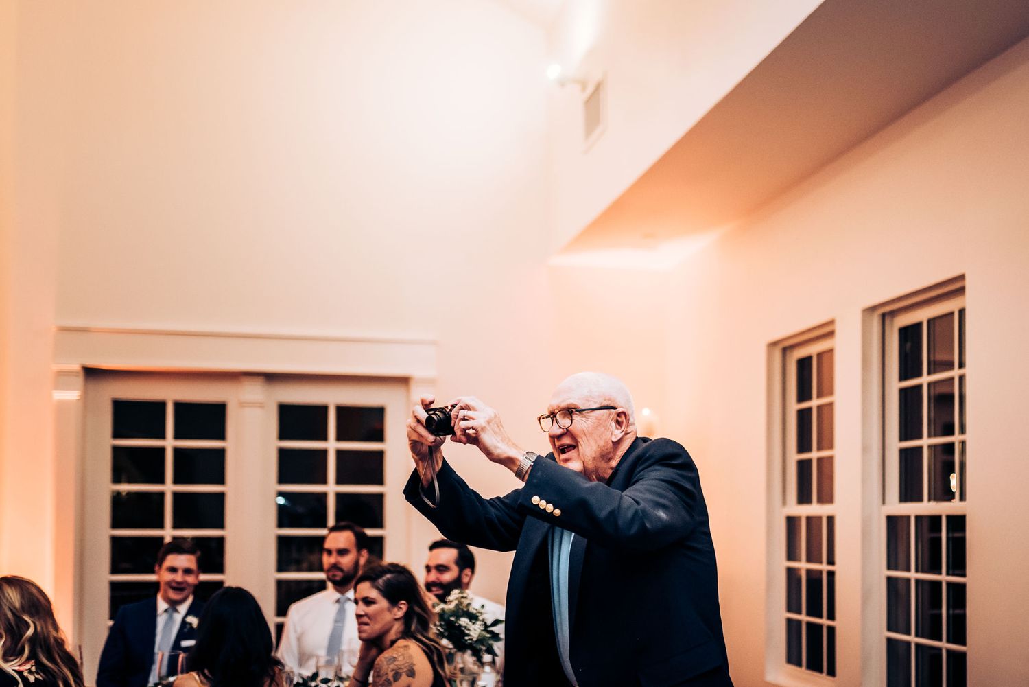 Guest raises a glass for a toast during wedding reception celebrations.