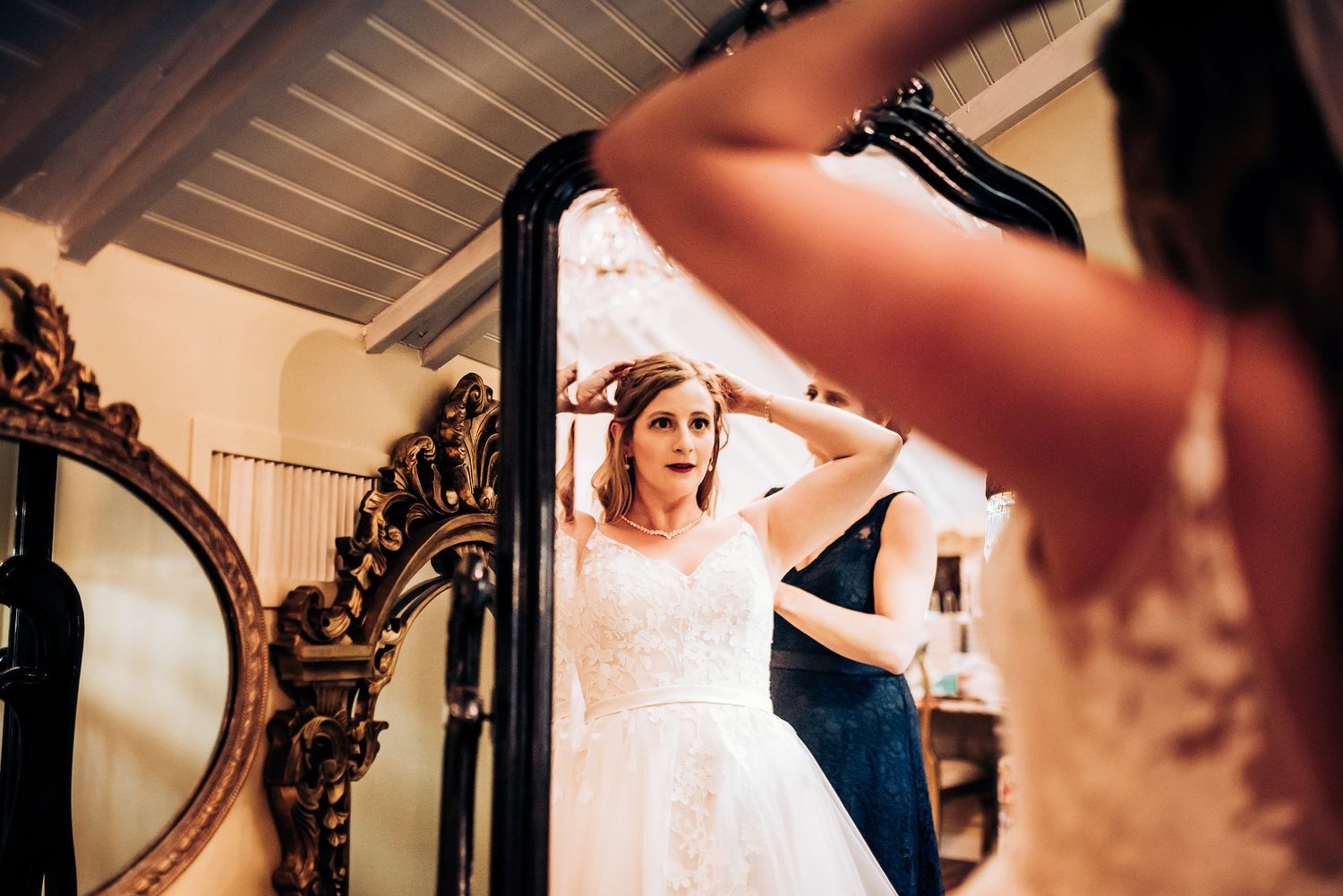 Wedding preparation scene with ornate mirror reflections and final dress adjustments.