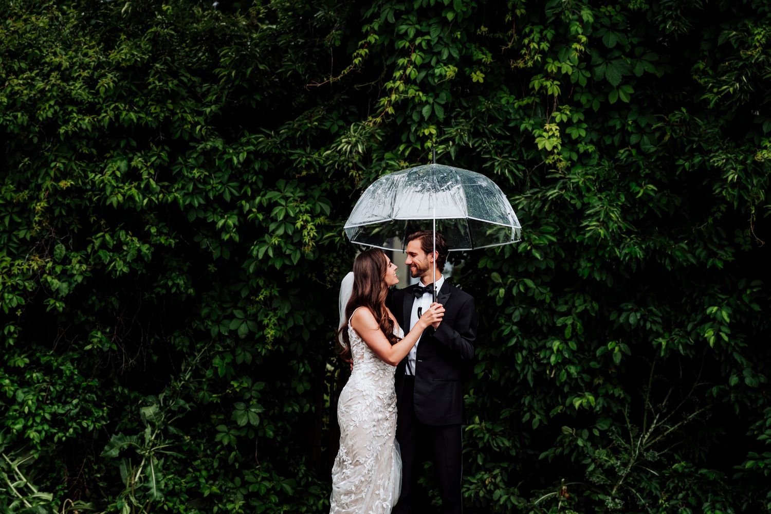 Wedding portraits in a lush green garden setting with natural light.
