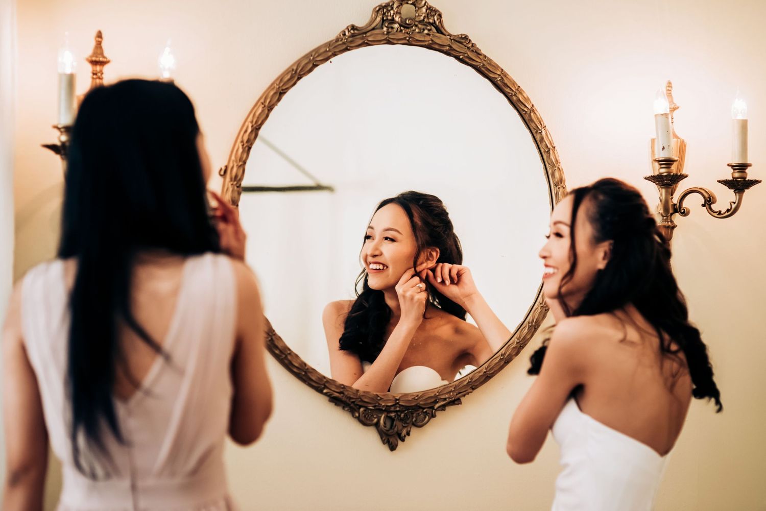 Wedding preparation scene with ornate vintage mirror and candlelight.