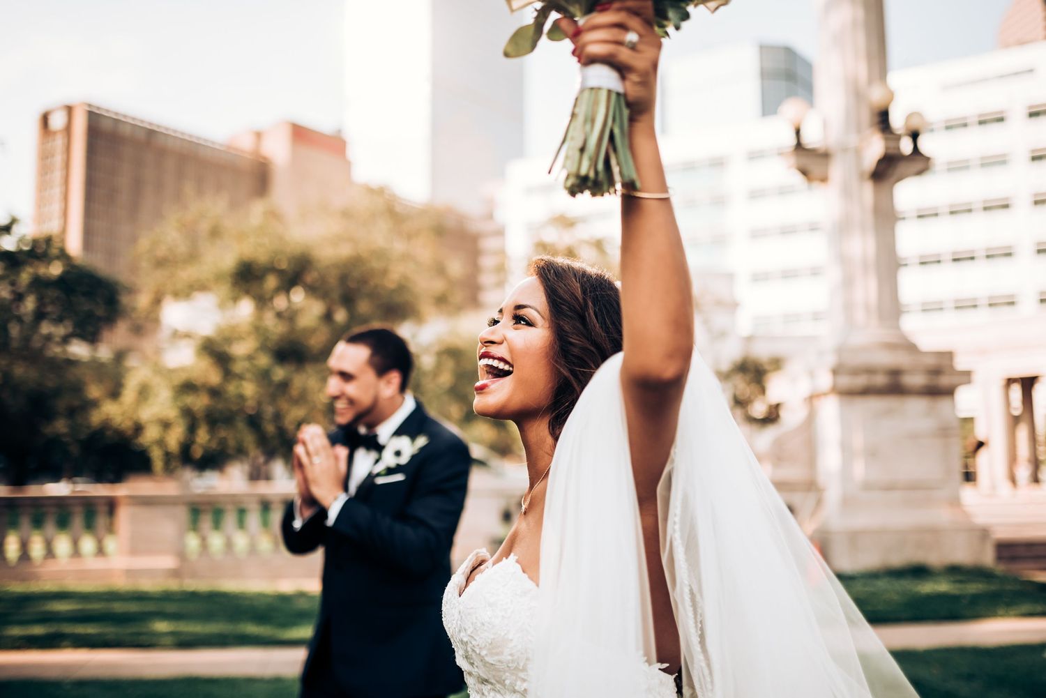 Wedding guests dance and celebrate under string lights at an outdoor reception.