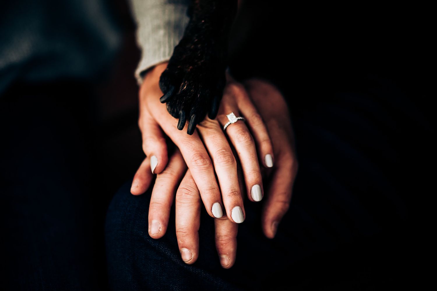 Close up of hands with engagement ring showing newly engaged couple.
