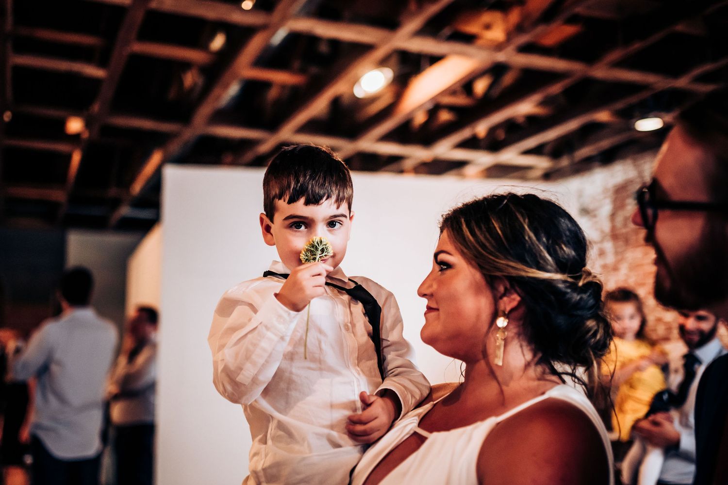 Candid moment during wedding reception in industrial venue.