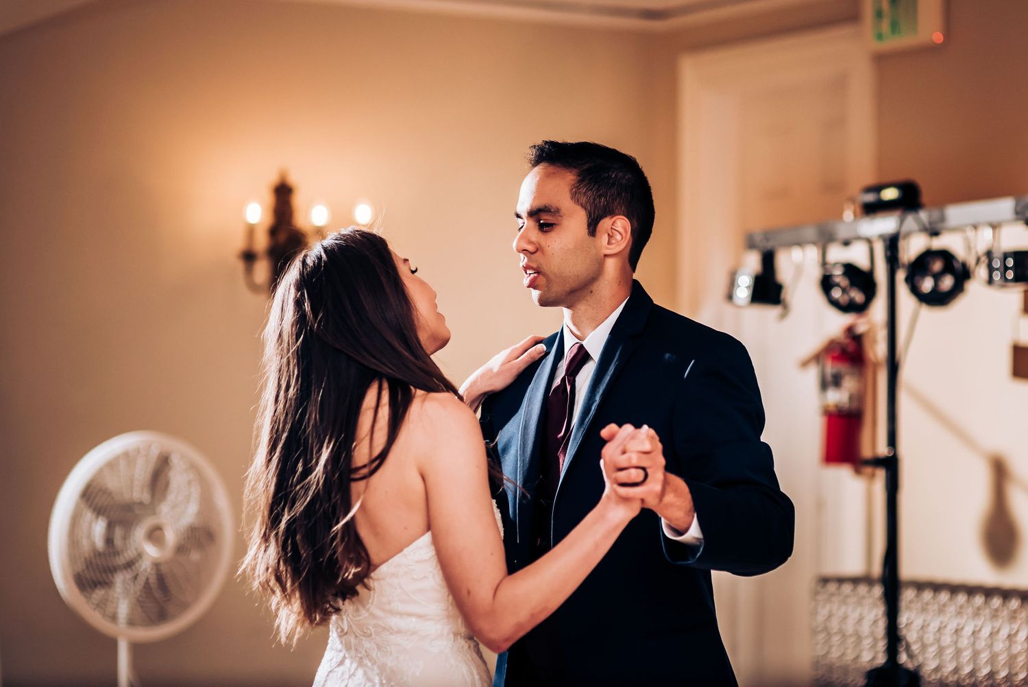 A couple dances together during their romantic first dance at the reception.