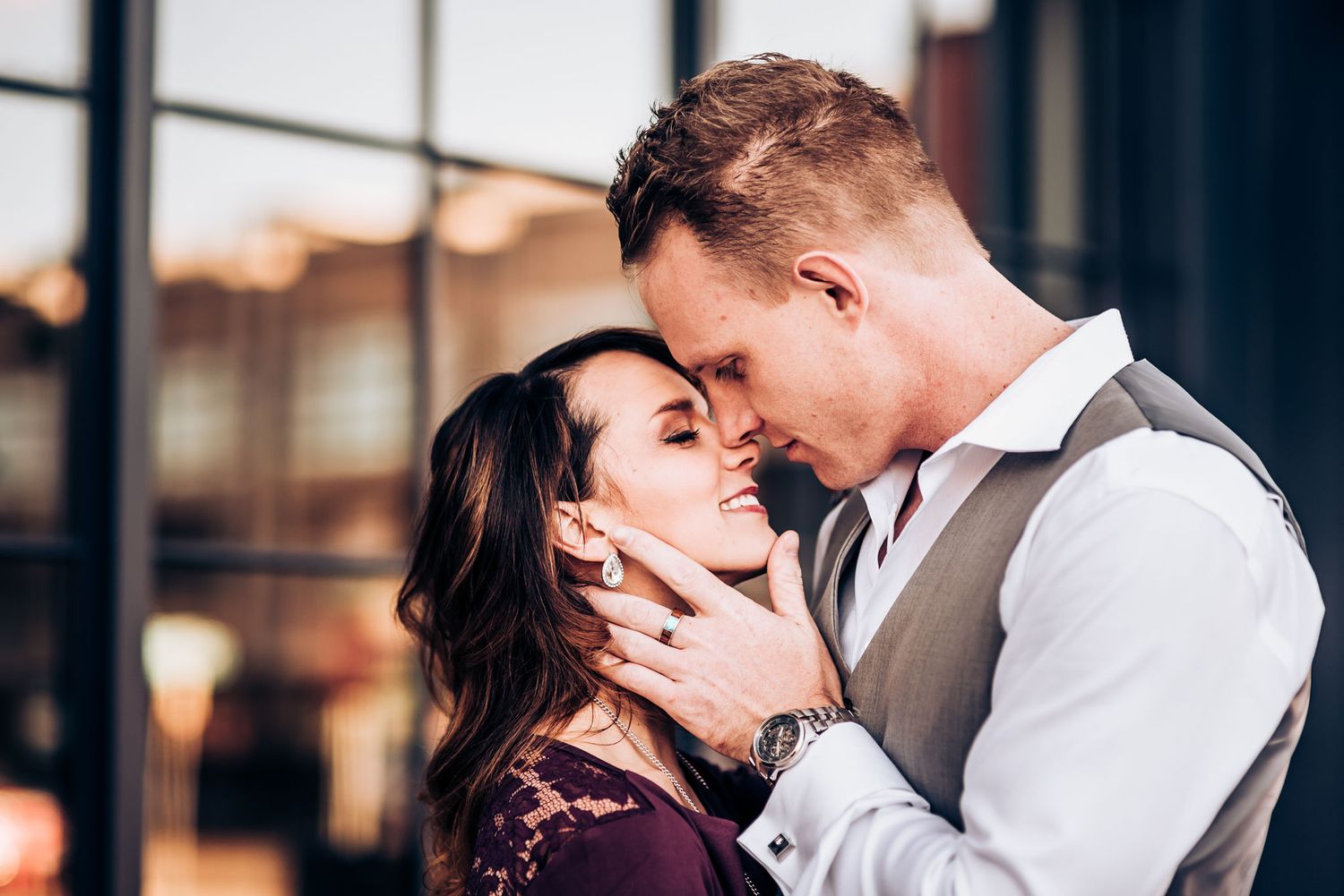 Intimate romantic moment shared during golden hour urban photoshoot.