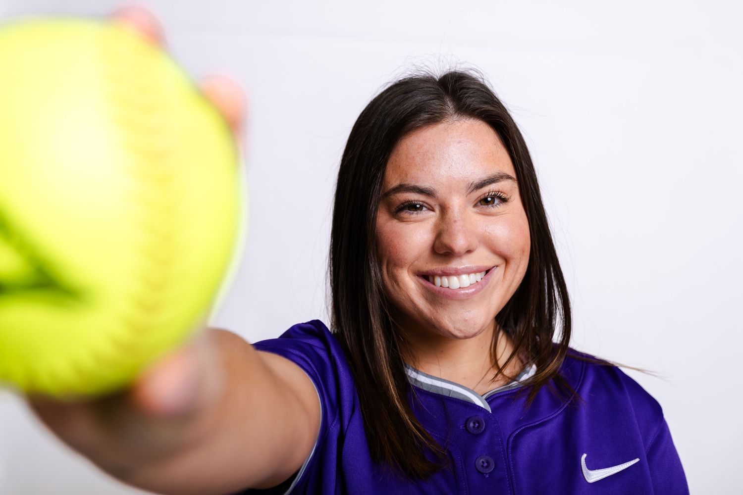 Series of profile portraits showing athlete in purple sports uniform against white background.