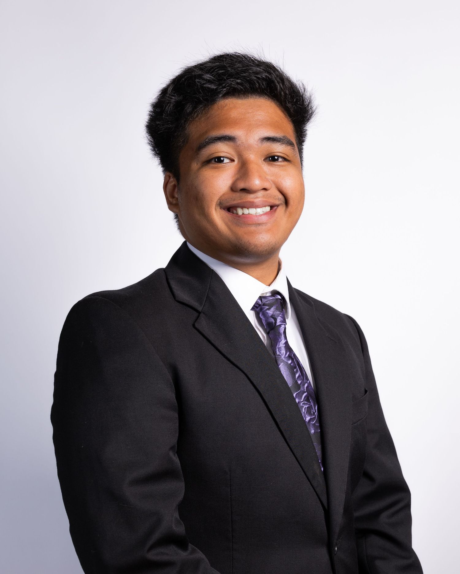 Professional headshots in business attire against white backdrop.