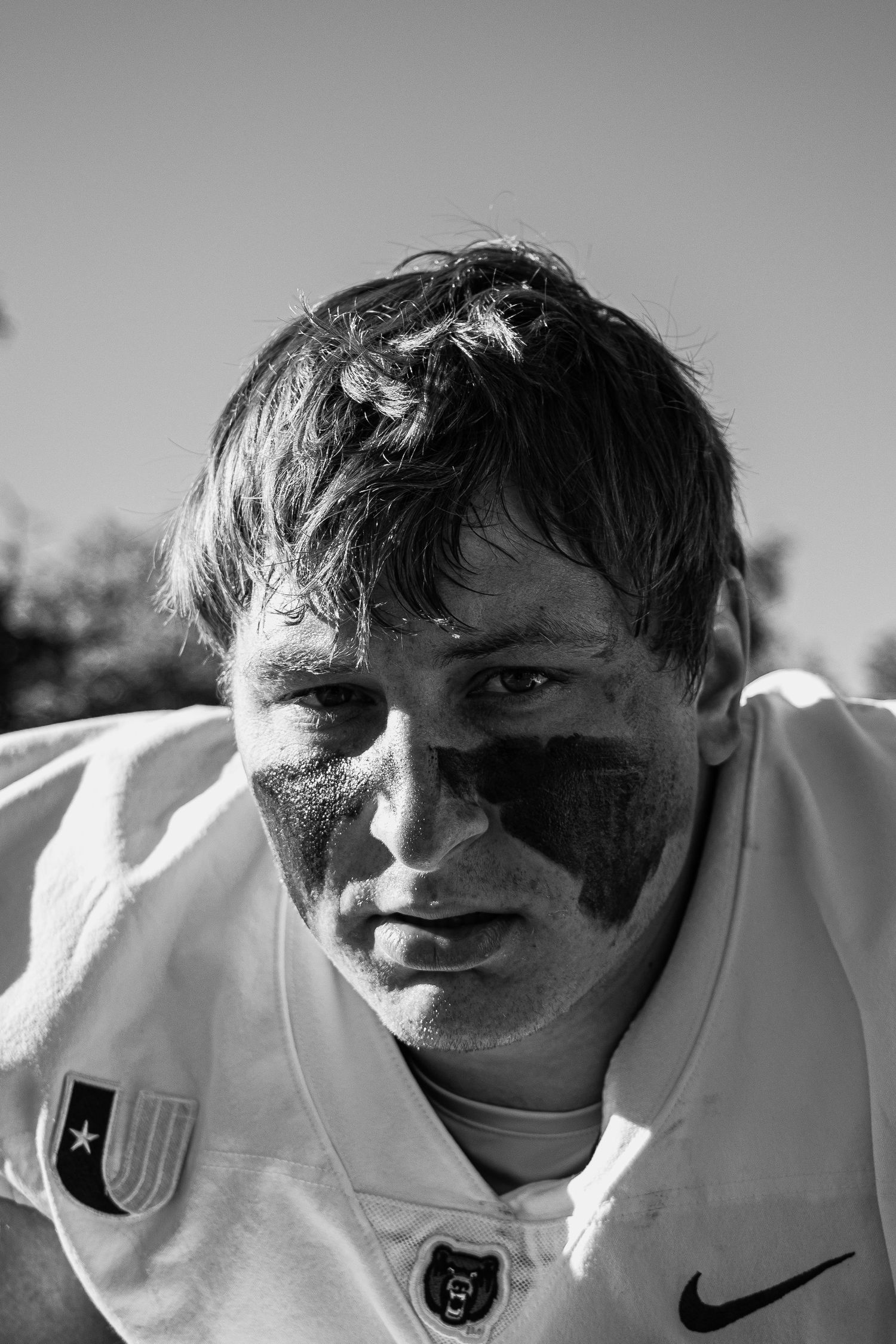 Close-up shot of player wearing white Nike jersey in black and white photography.