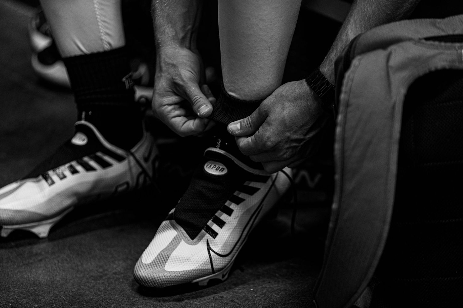 Close-up of athletic shoes and cleats on soccer players during match.