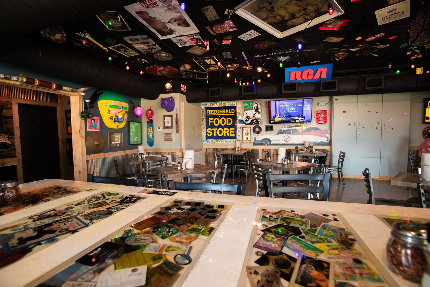 Interior of casual dining restaurant with tables and nostalgic wall decorations.