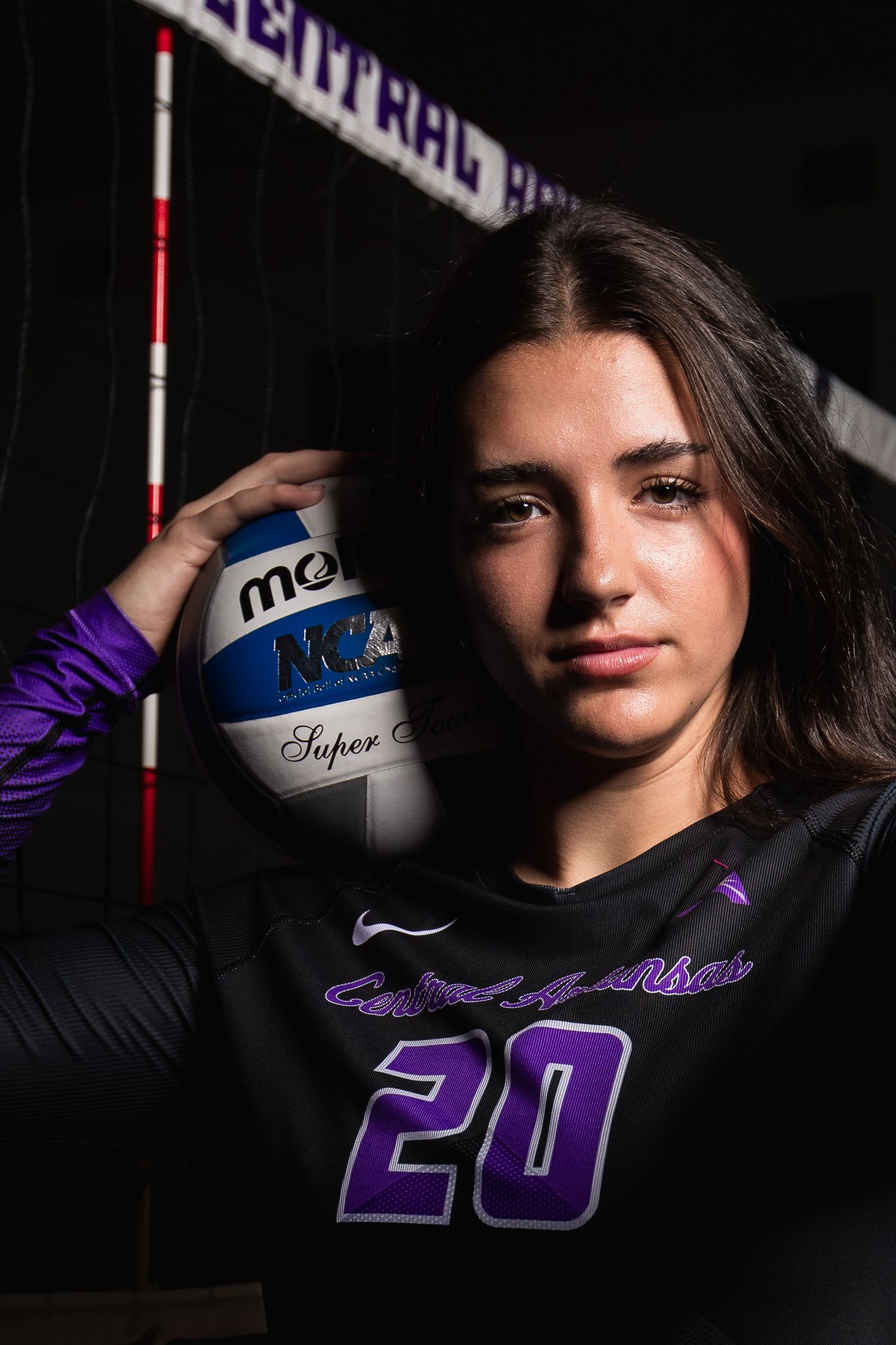 Moody sports portraits featuring volleyball player in black uniform with number 28.