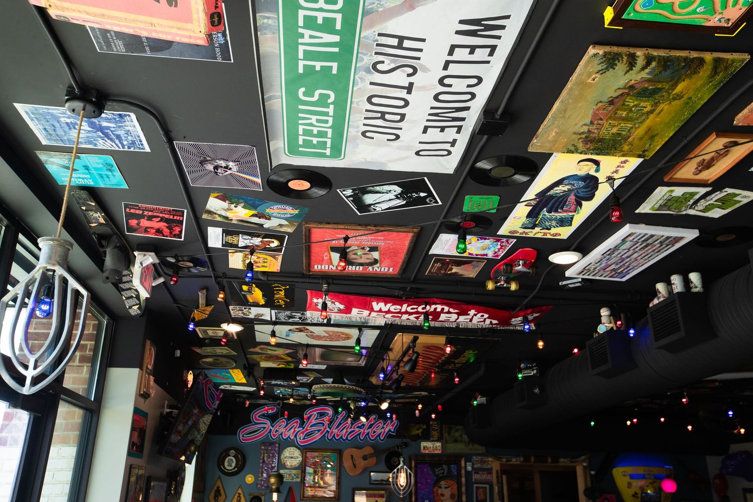 Bar interior with ceiling decorated in vintage signs, license plates and nostalgic memorabilia.