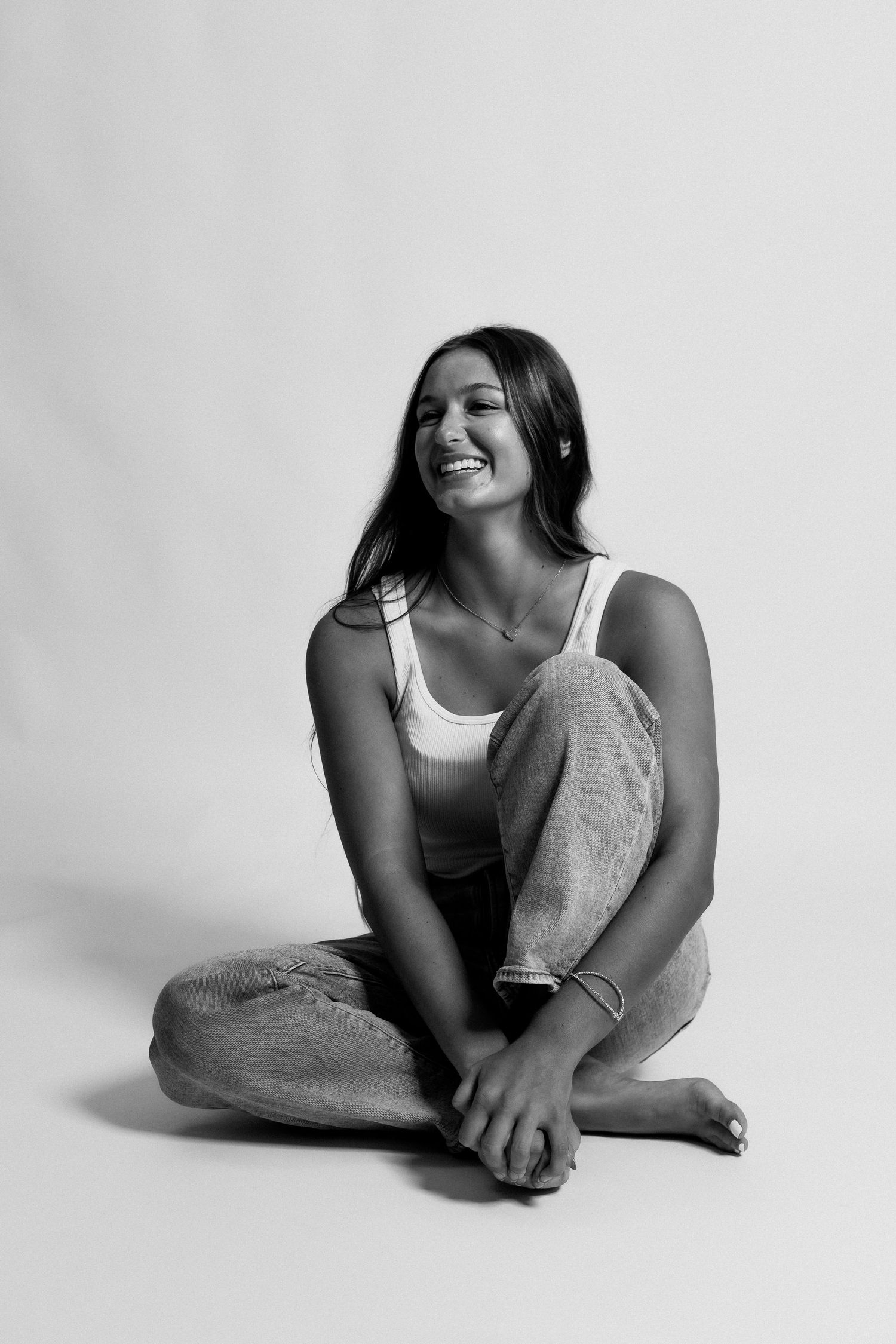 Black and white artistic photography series showing relaxed poses against a minimalist white background.