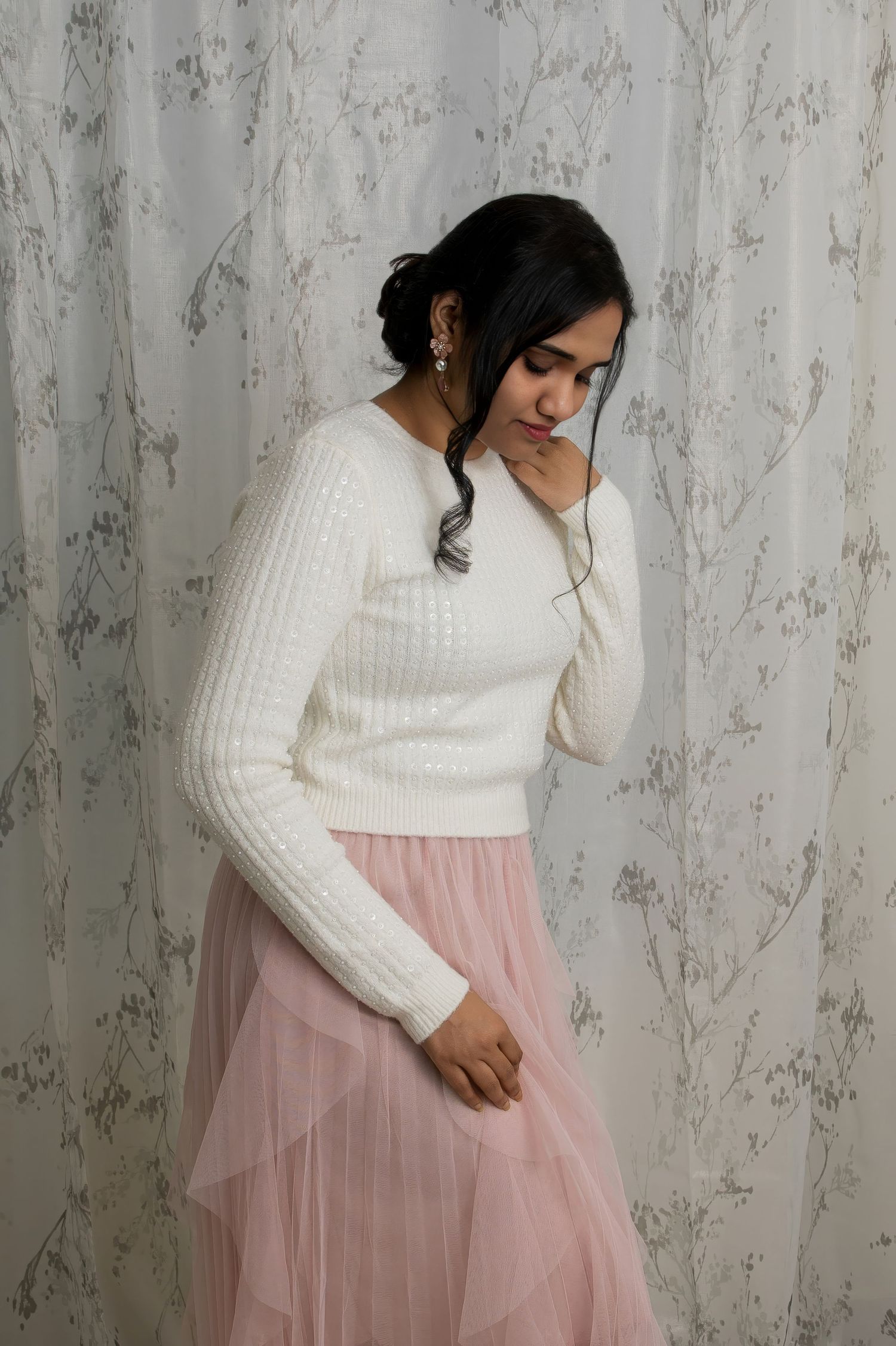A cream ribbed sweater paired with pink tulle skirt creates an ethereal winter fashion look.