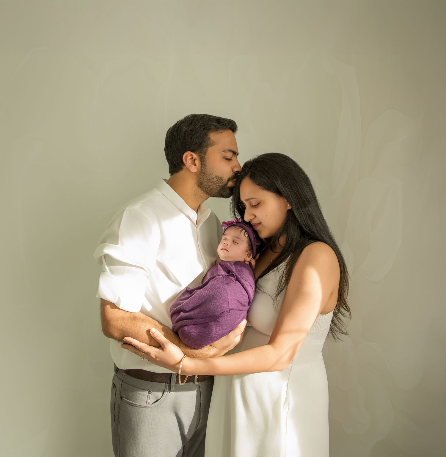 Emotional family photoshoot sequence showing intimate moments against neutral background.