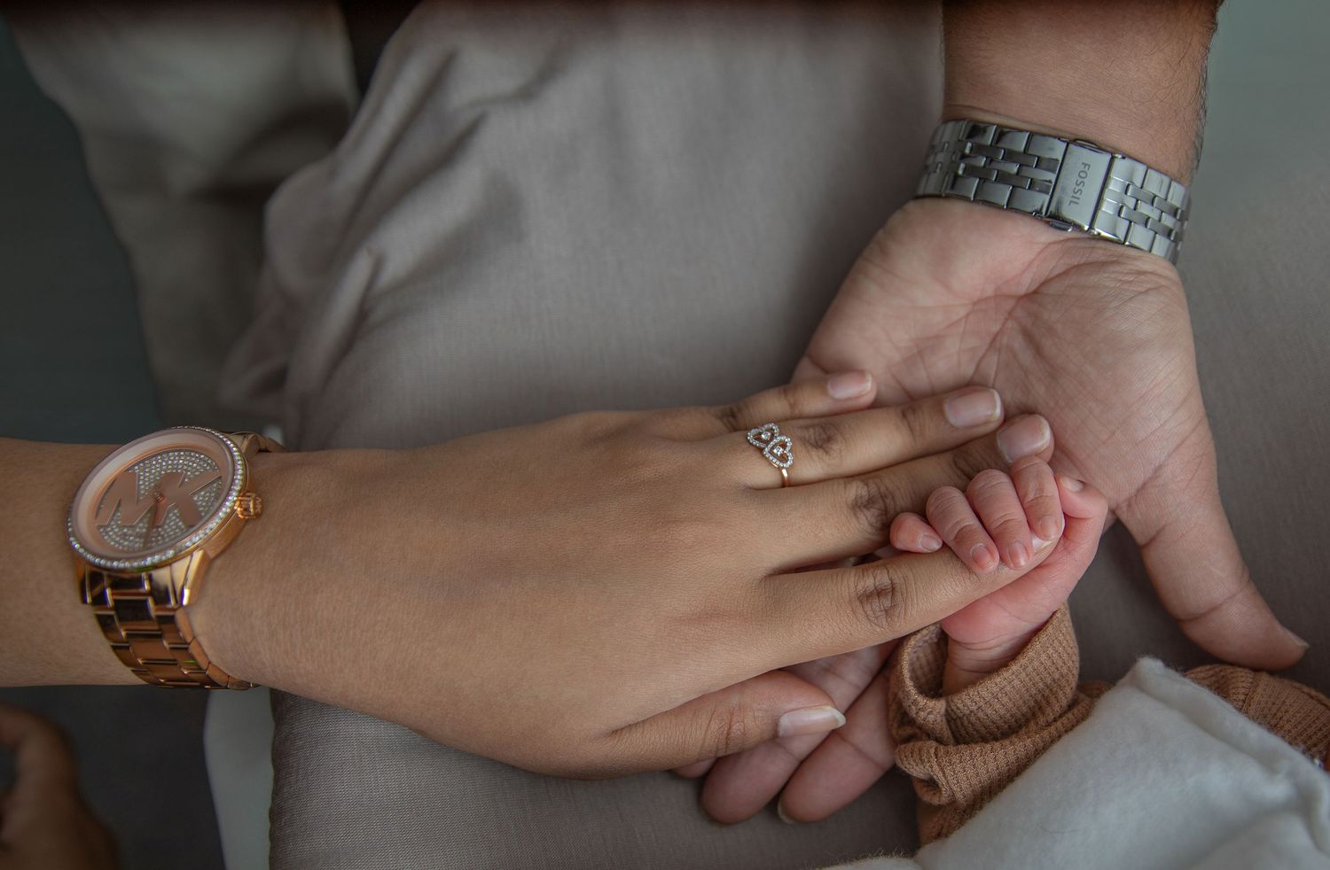 Two people hold hands together in a close-up sequence of photos showing different hand-holding positions and angles.