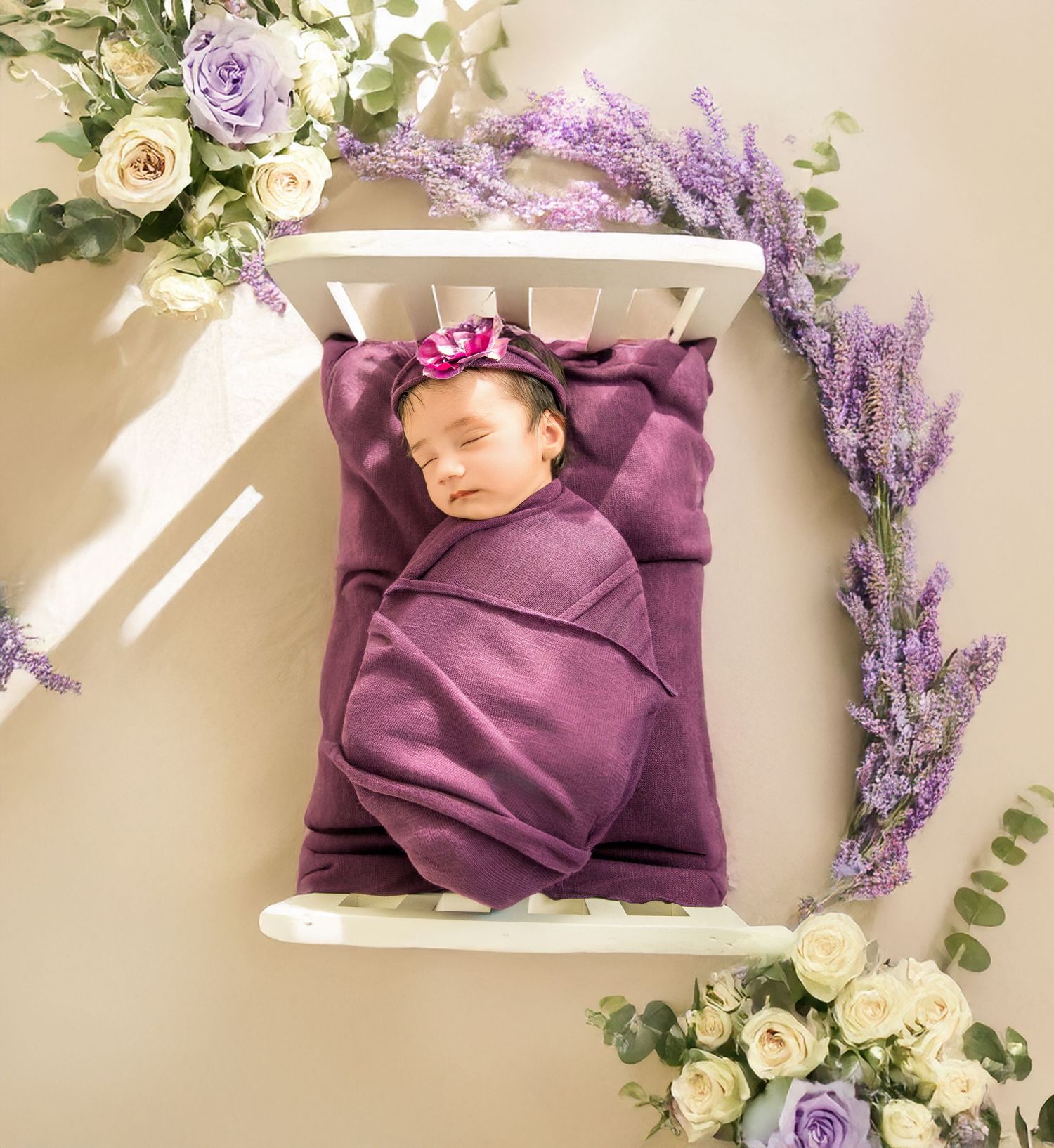A sleeping newborn surrounded by purple and lavender floral arrangements in a dreamy setting.