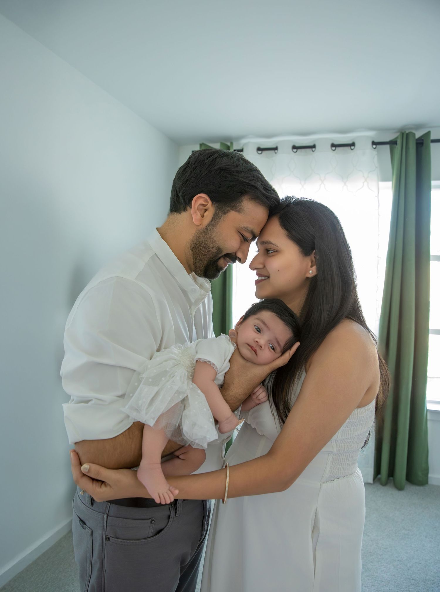 A collection of intimate family portraits showing tender moments with a newborn in a bright room.