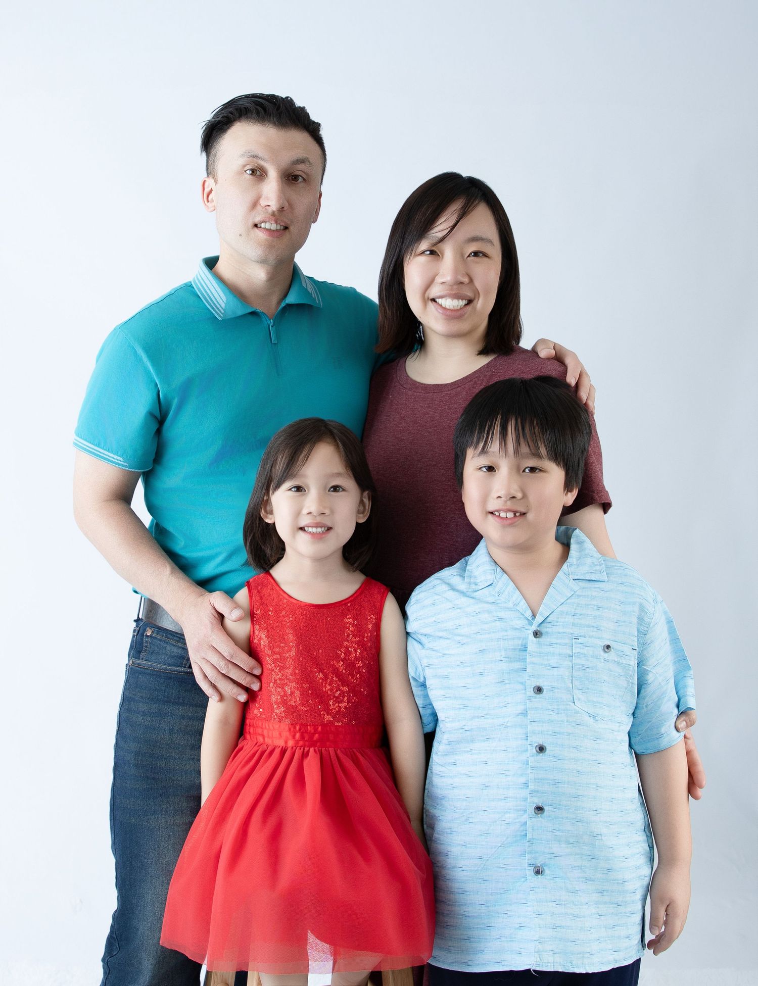 Family portrait with children in coordinated casual outfits.