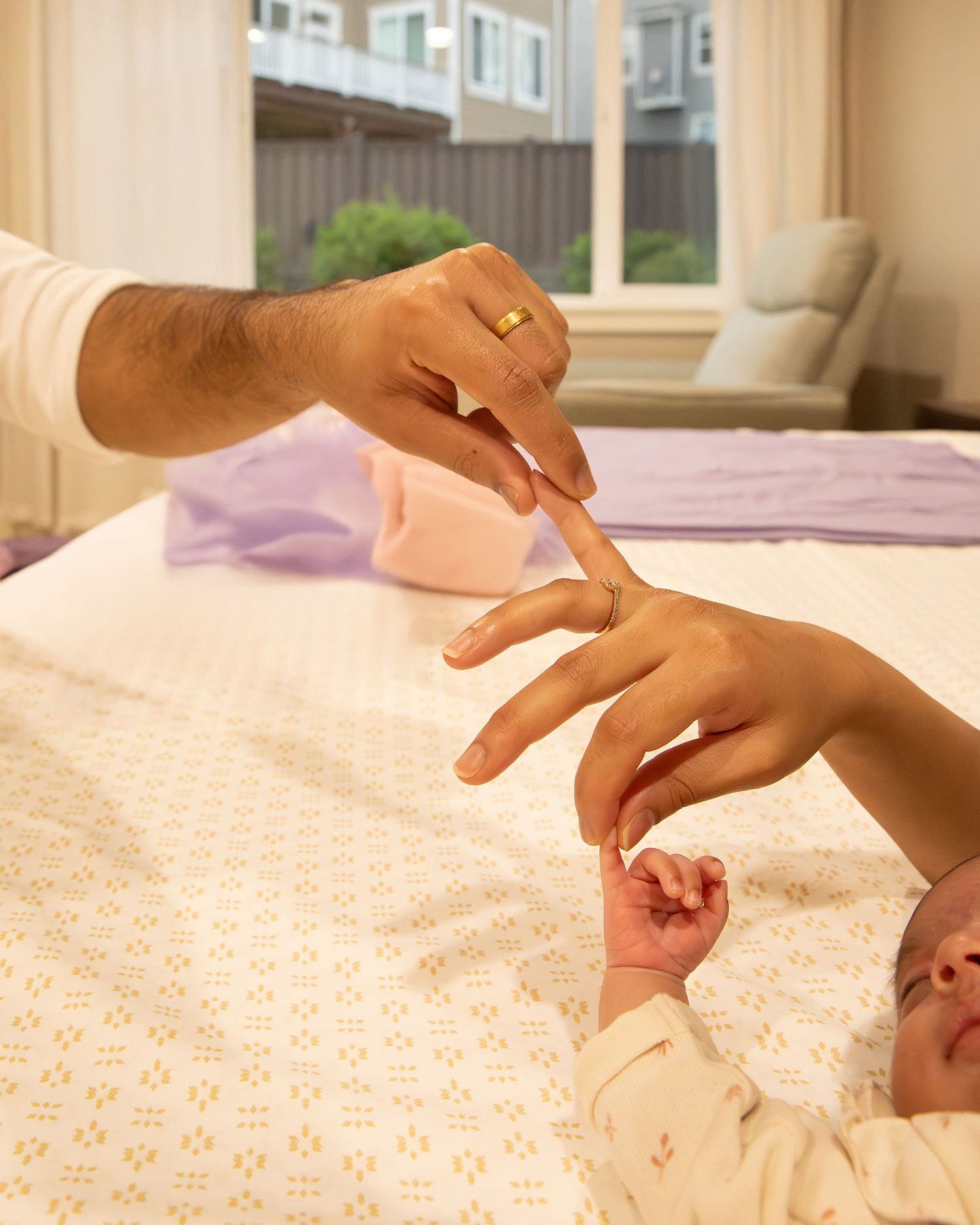 A close-up demonstration of infant baby massage techniques being performed on a soft surface.