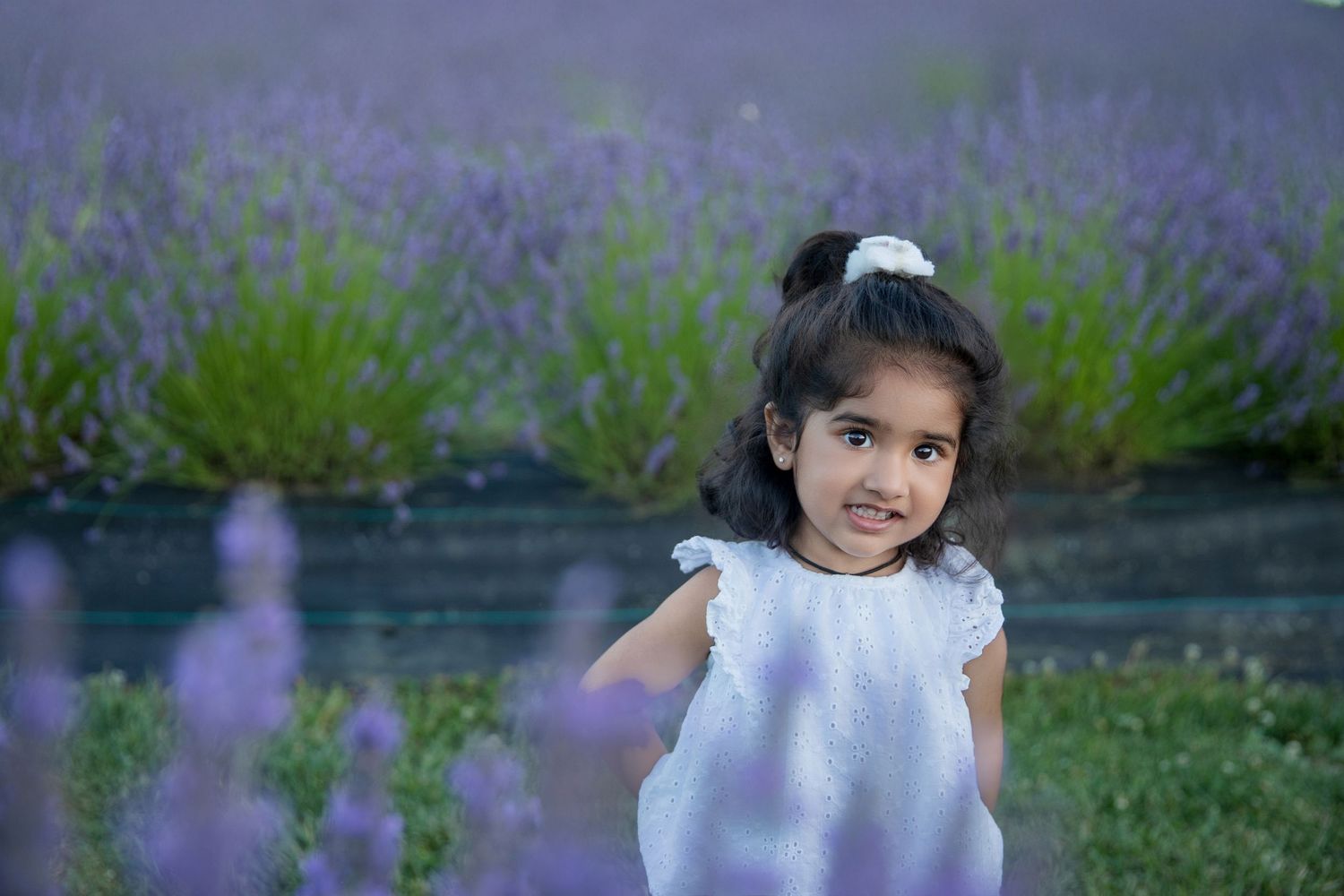 Candid summer portrait among blooming lavender flowers.