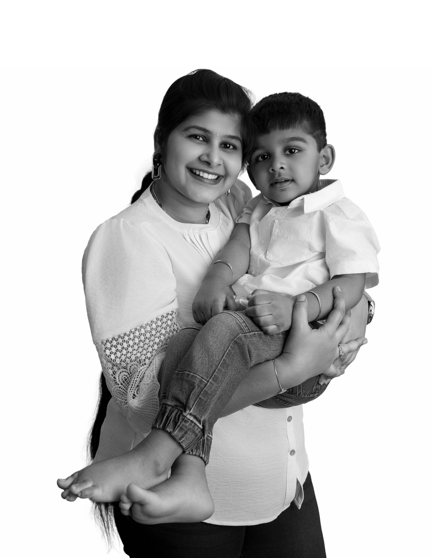 Black and white portrait of family members embracing in casual attire.
