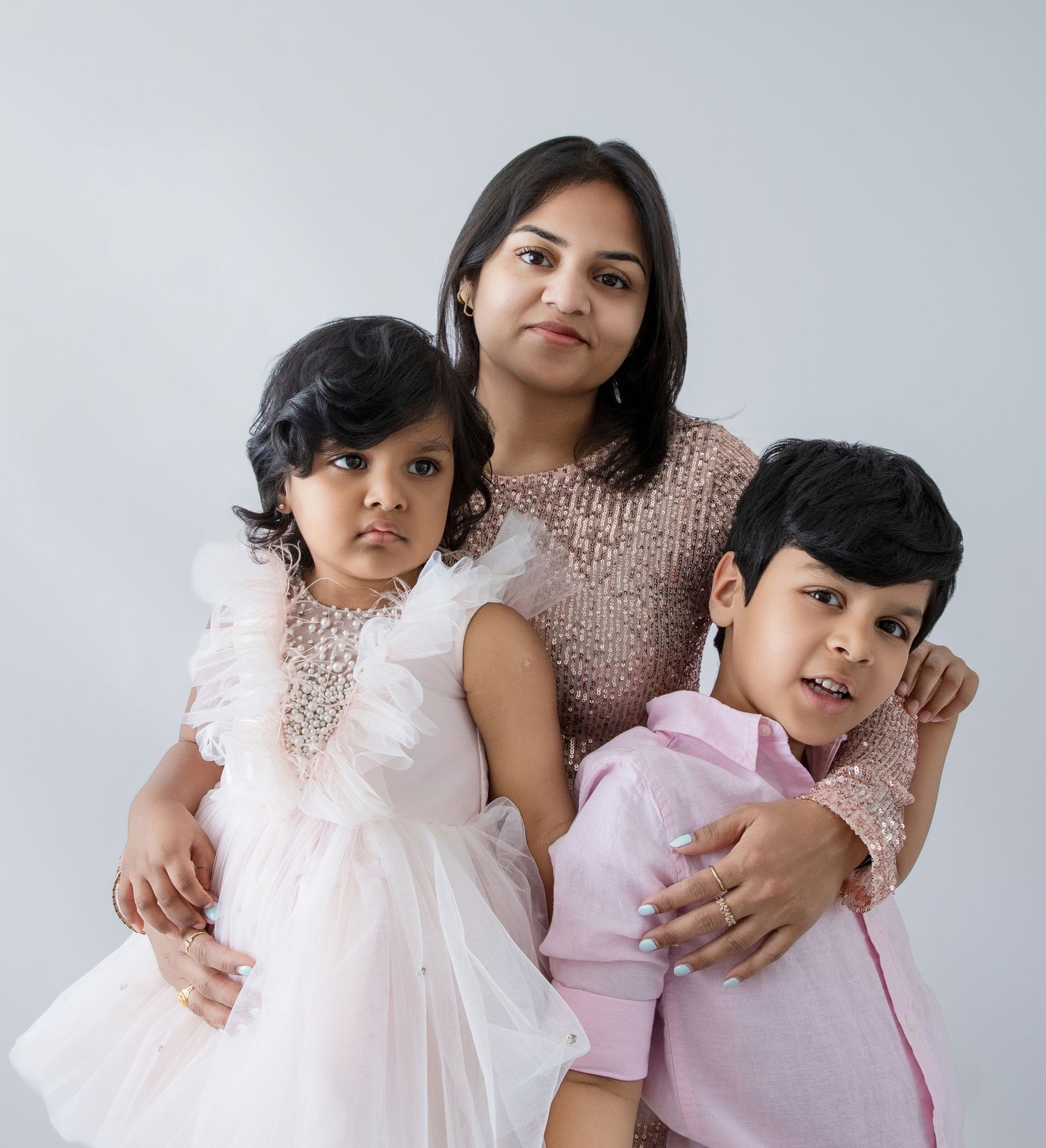 Professional family portrait sequence with blush pink and white color coordination.
