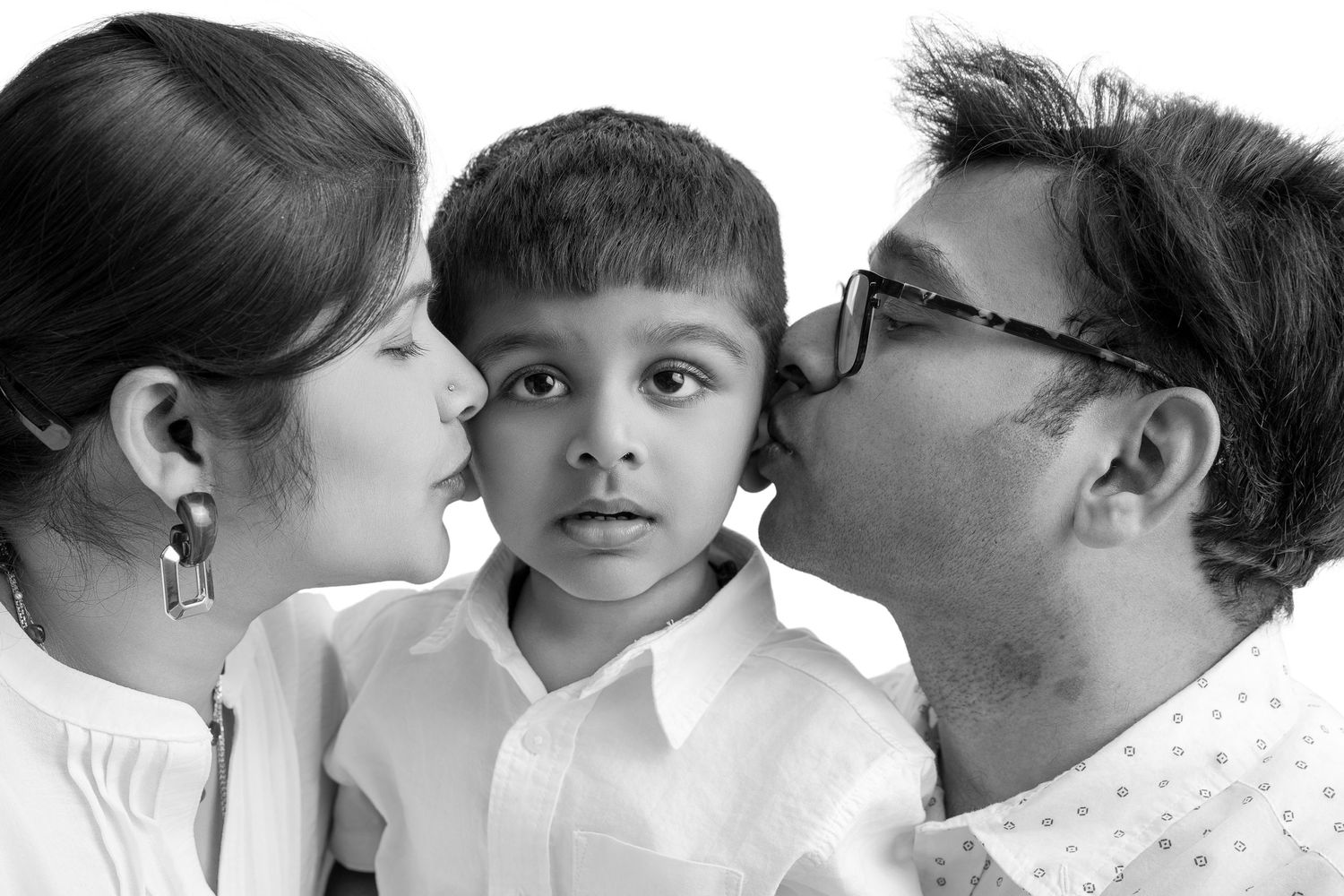 Series of black and white close-up family portraits showing affectionate moments.
