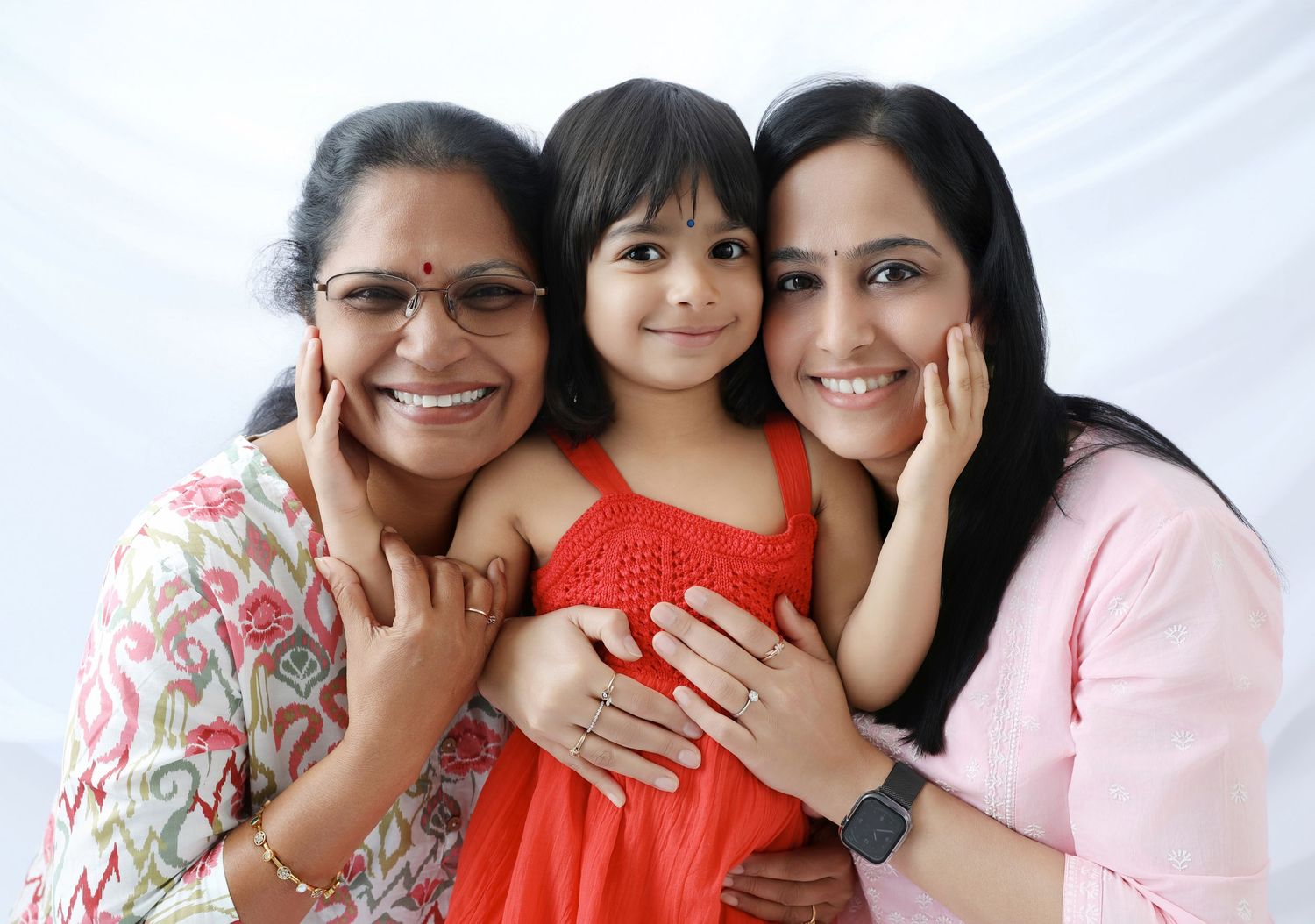 Joyful family portrait series with bright red and pink color scheme.