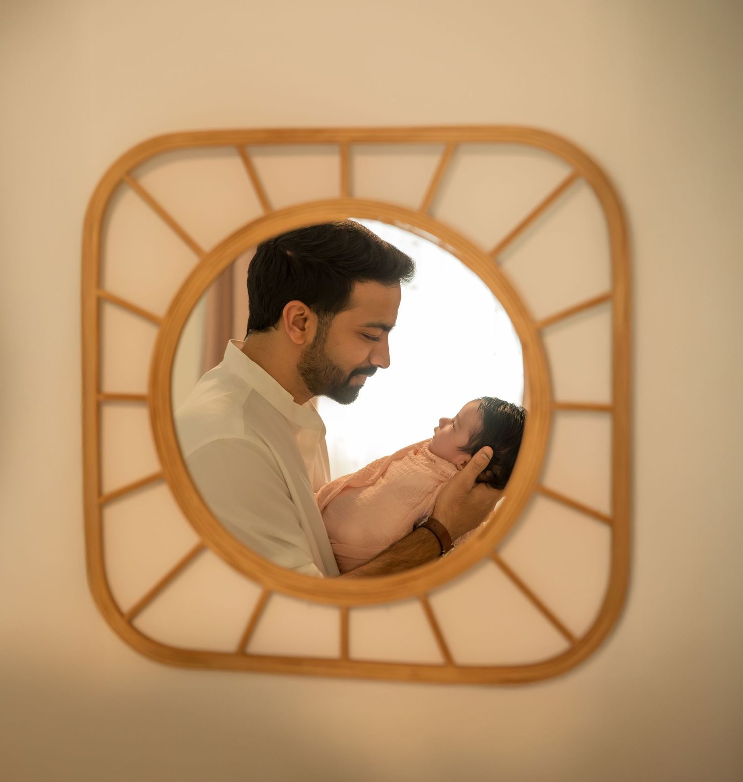 A series of artistic window frames showing intimate family moments in warm sepia tones.