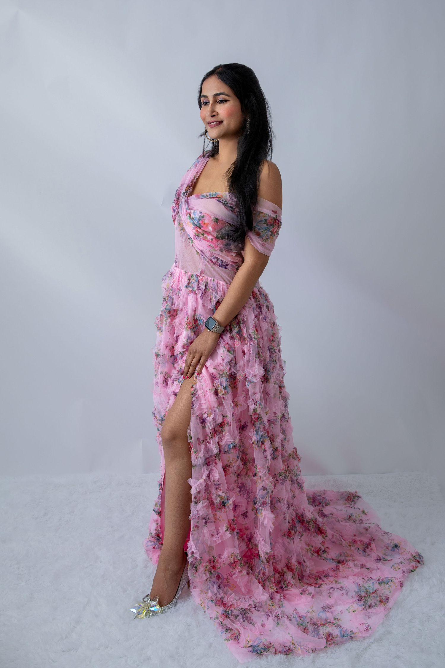 Flowing pink floral gown with textured details photographed in artistic studio poses.