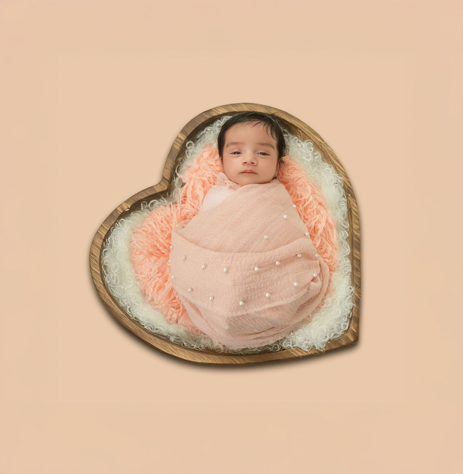 Artistic newborn photography series showing baby in pink swaddle on curved prop.