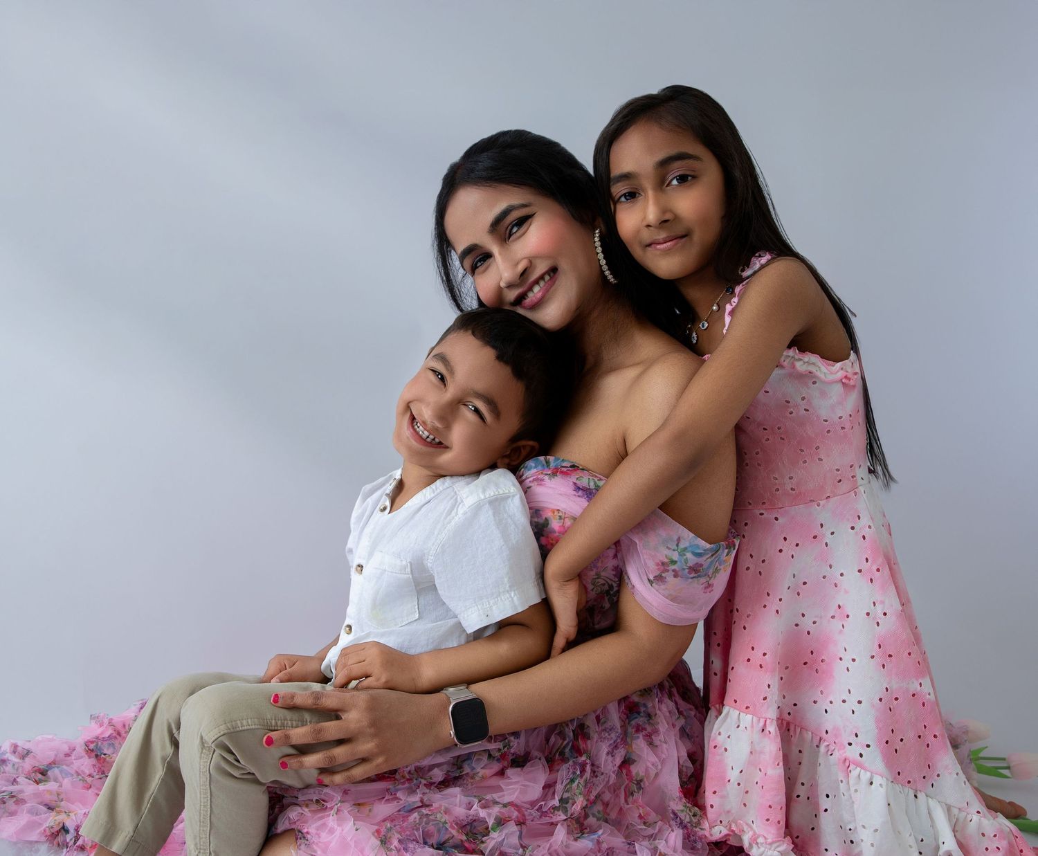 Beautiful family portraits with coordinated pink and white outfits.