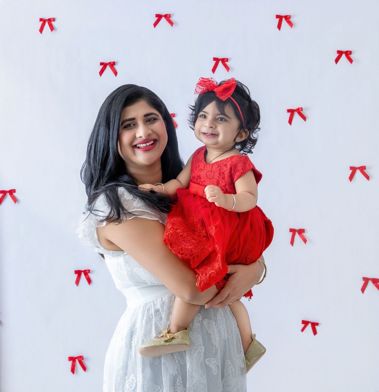 Family photo session with white and red theme featuring matching dresses.