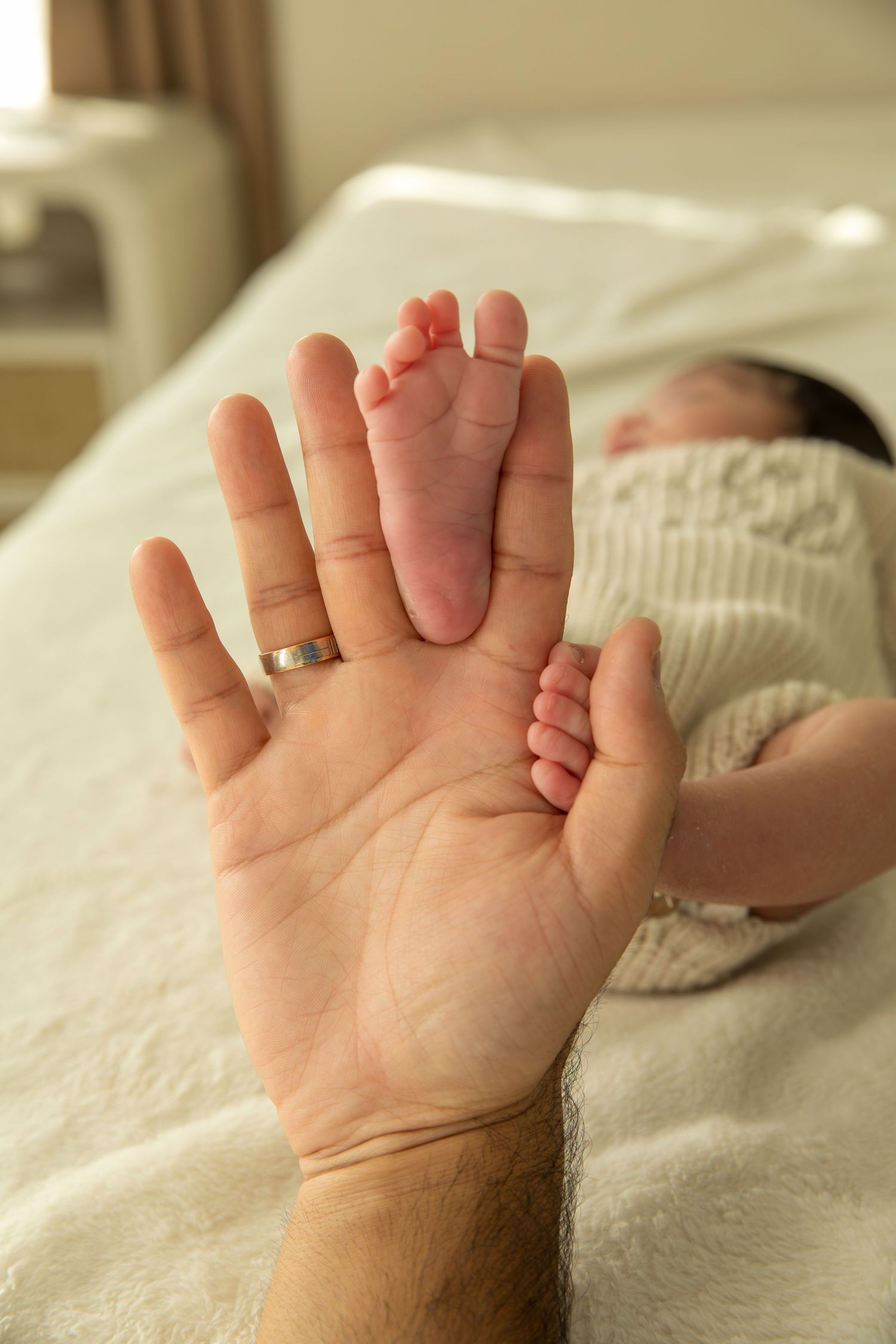 Close-up series of tiny baby feet and toes resting on soft white bedding.