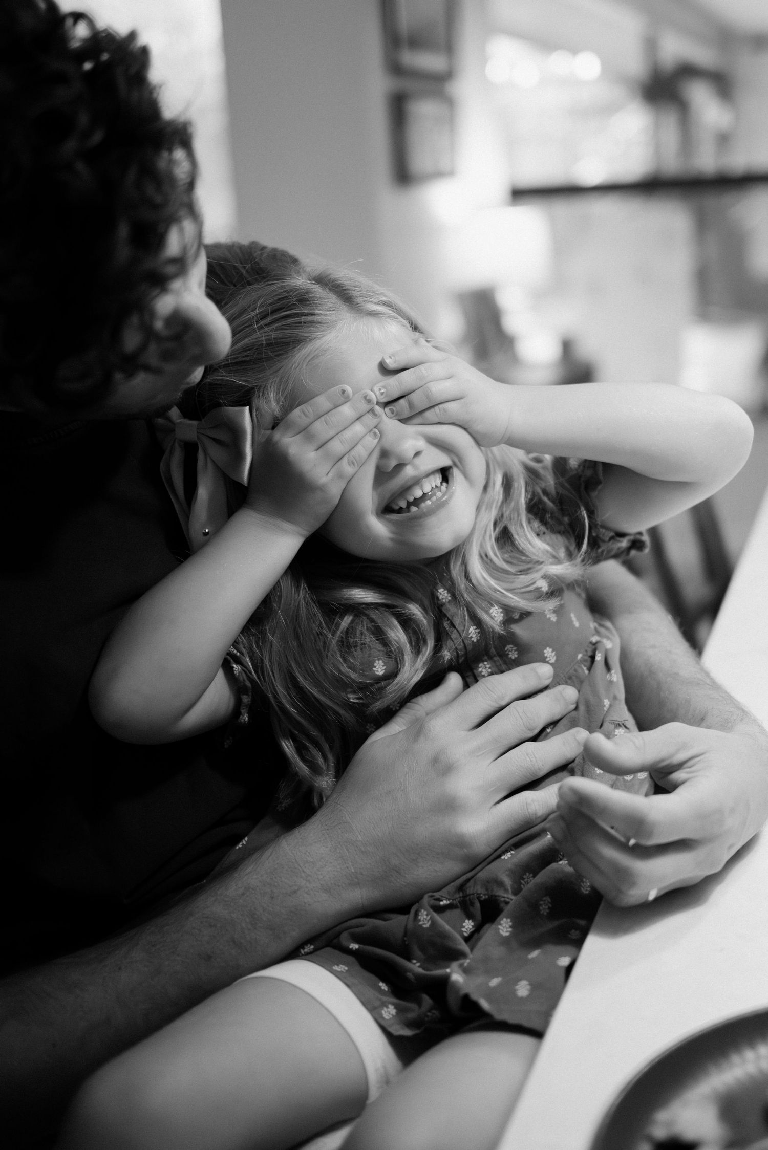 A series of intimate black and white photographs showing playful expressions and gestures in a candid moment.