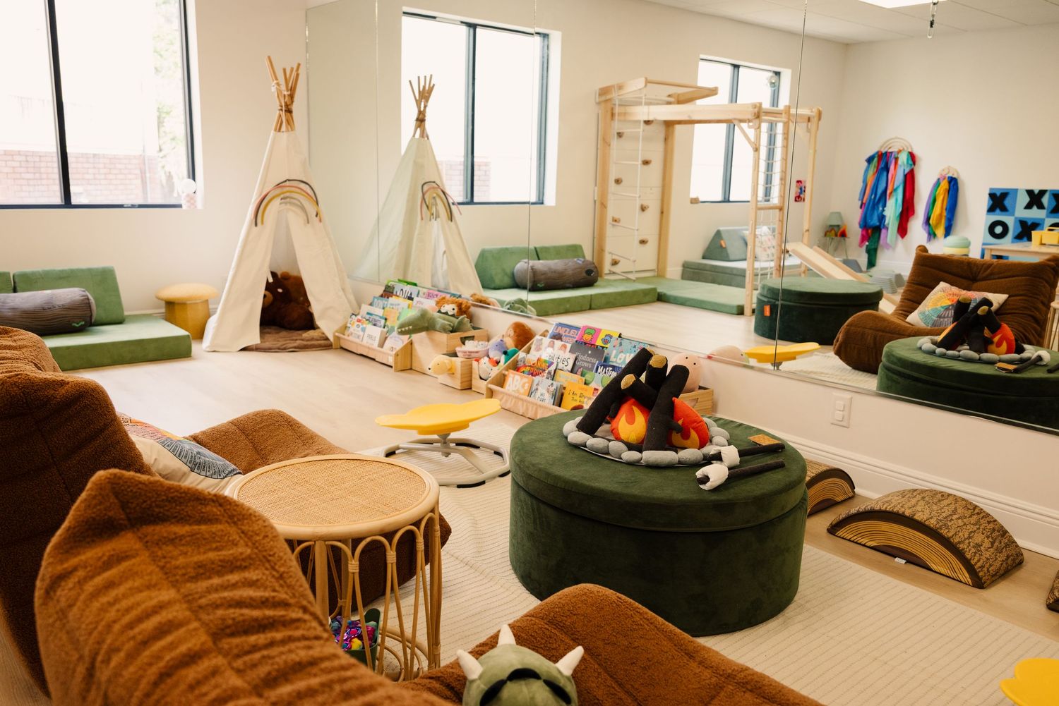 Modern playroom interior with comfortable seating and colorful decor.