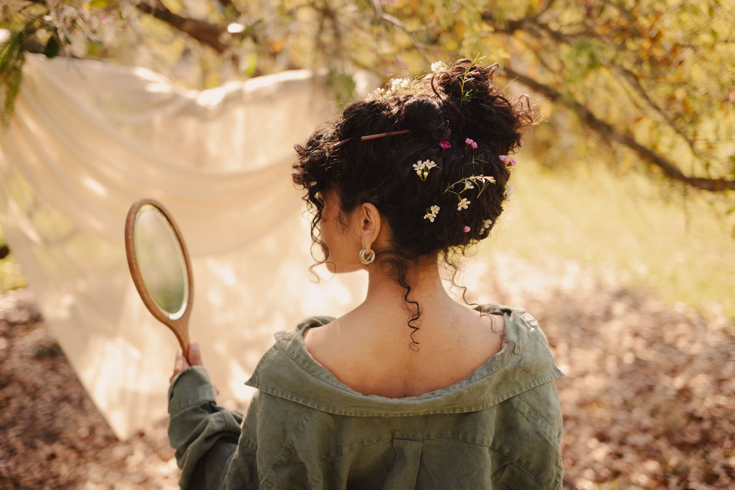 Romantic outdoor photoshoot with soft natural lighting and autumn foliage in background.