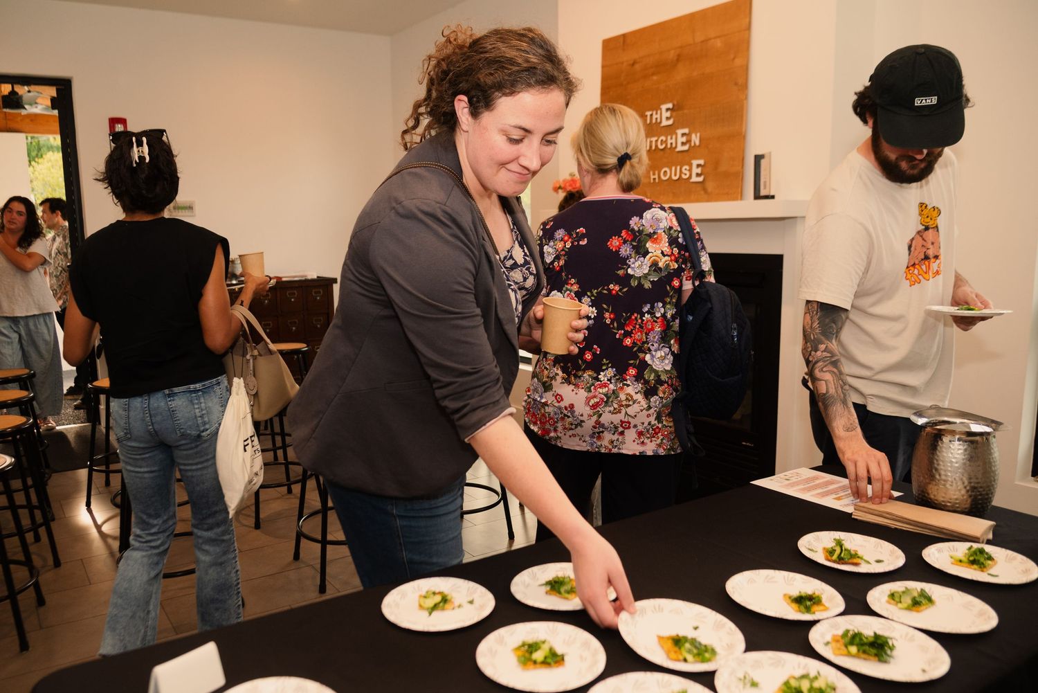 Food being plated and served at a casual dining event.