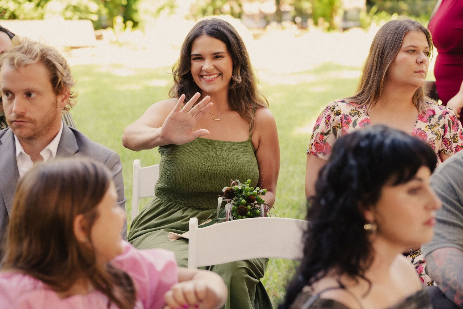 Wedding guests enjoying an outdoor celebration on a sunny day.