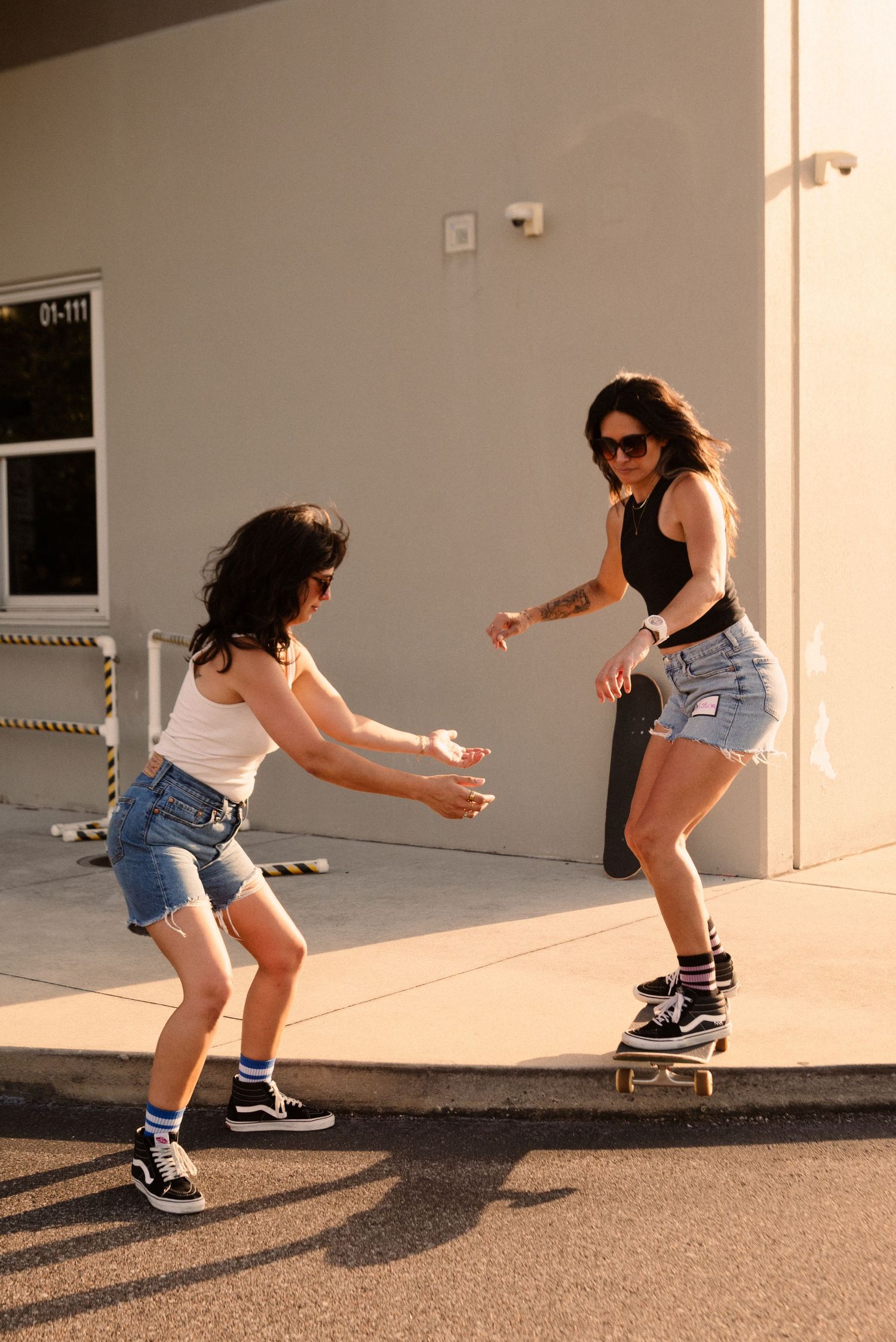 Low angle shots of skateboarding moves on a concrete surface with dramatic shadows.
