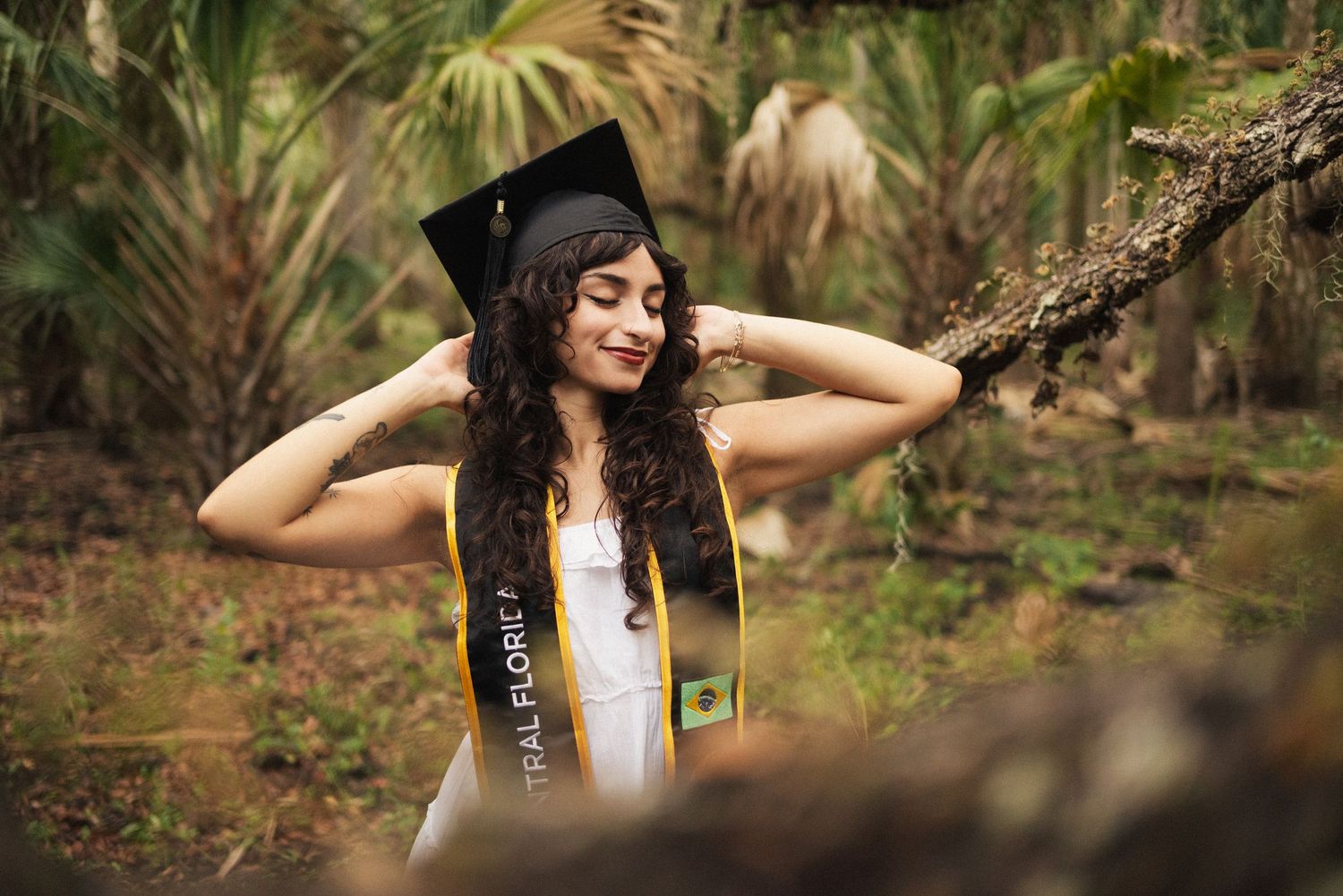 Artistic graduation photo sequence in a natural outdoor setting.