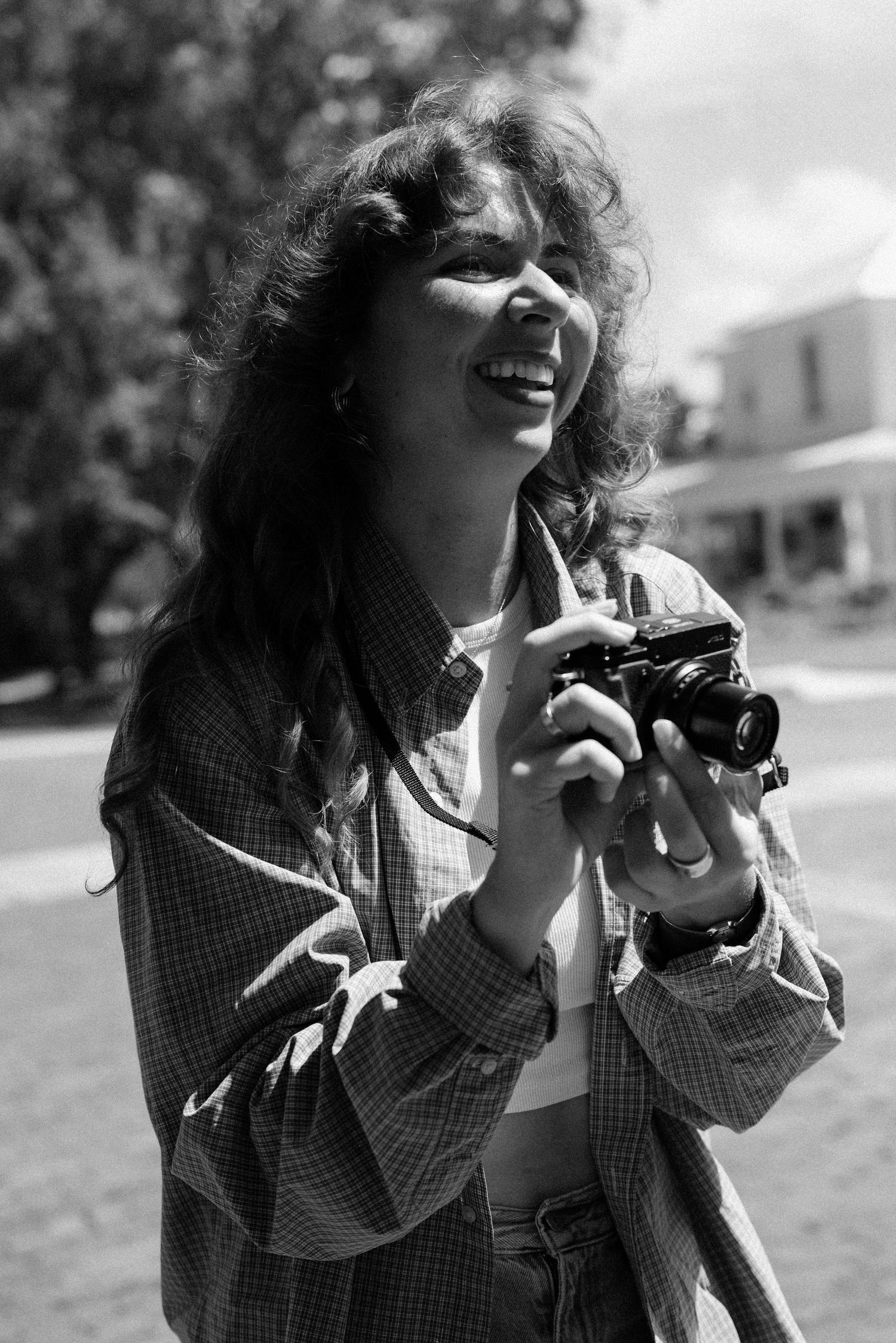 A series showing someone enthusiastically using a camera outdoors.