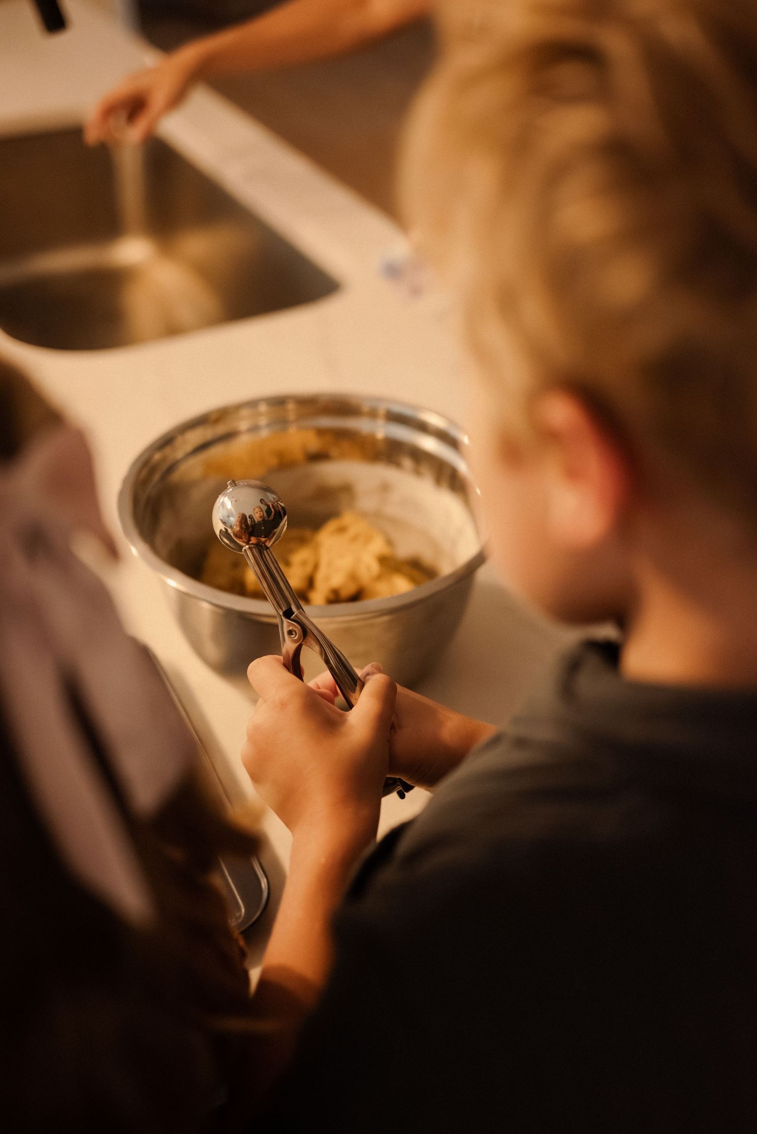 Warm-toned photo of hands mixing ingredients in a bowl.