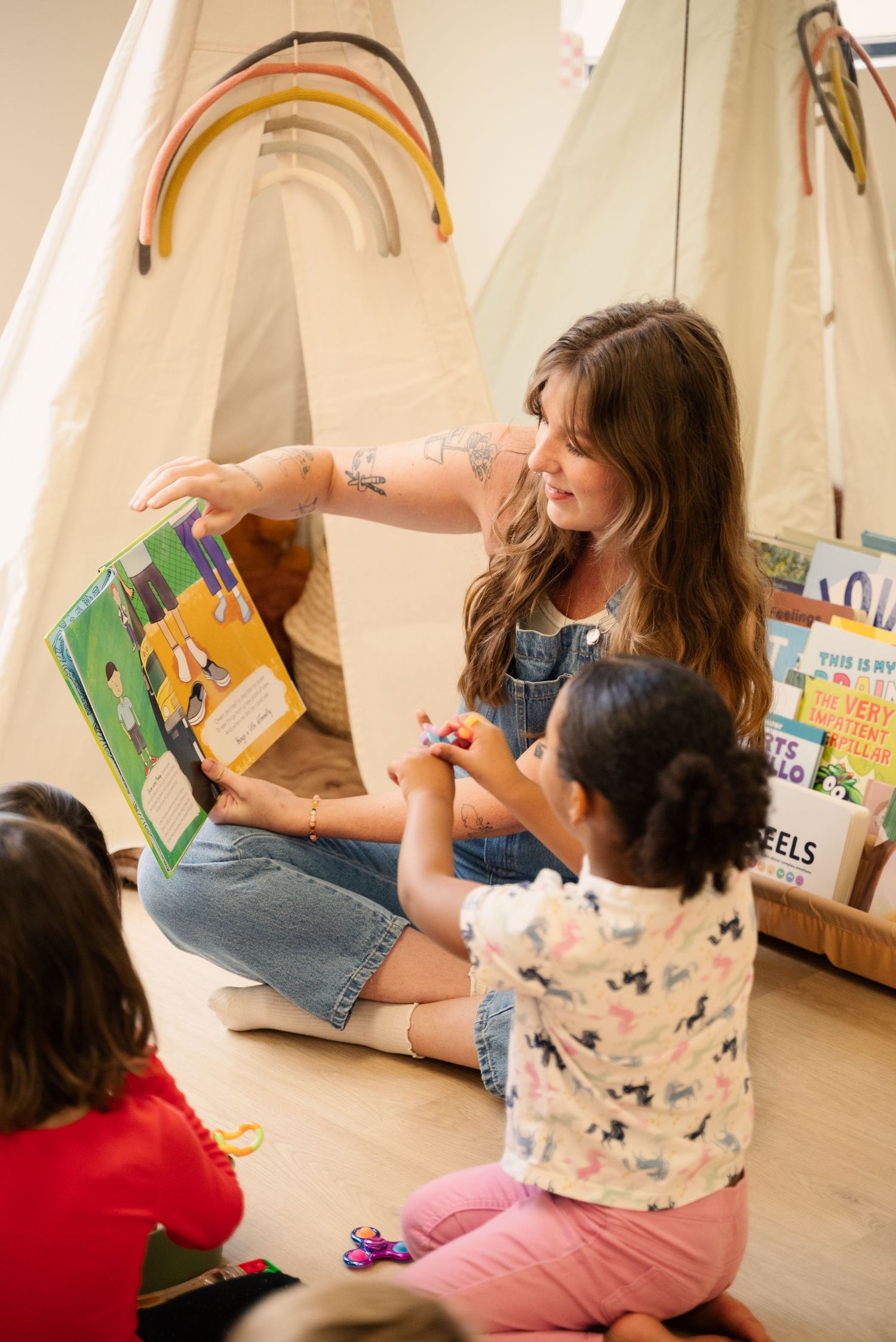 Story time activity with children sitting on the floor with books.