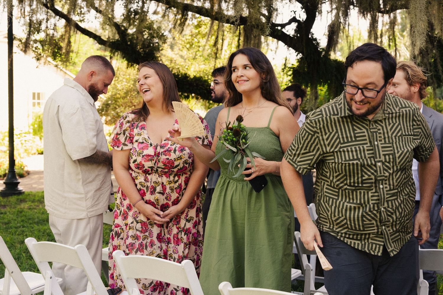 Wedding guests enjoying candid moments in casual attire at an outdoor celebration.
