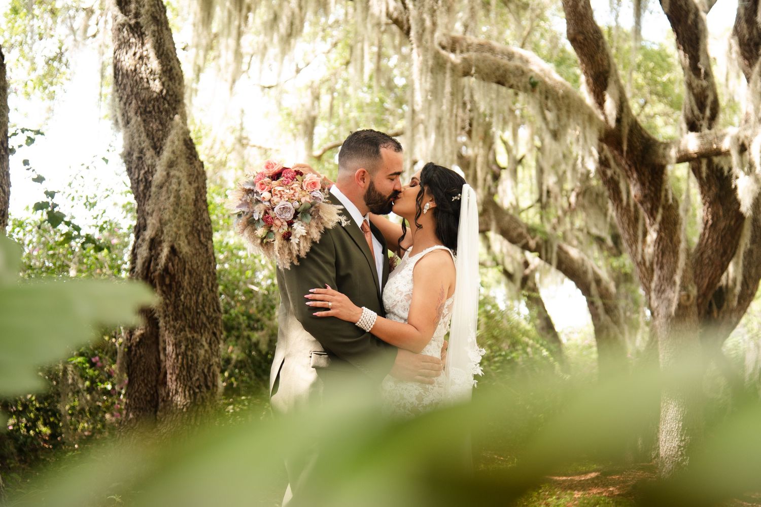 Central Florida wedding photographer captures couple with mossy trees in Winter Haven, Florida