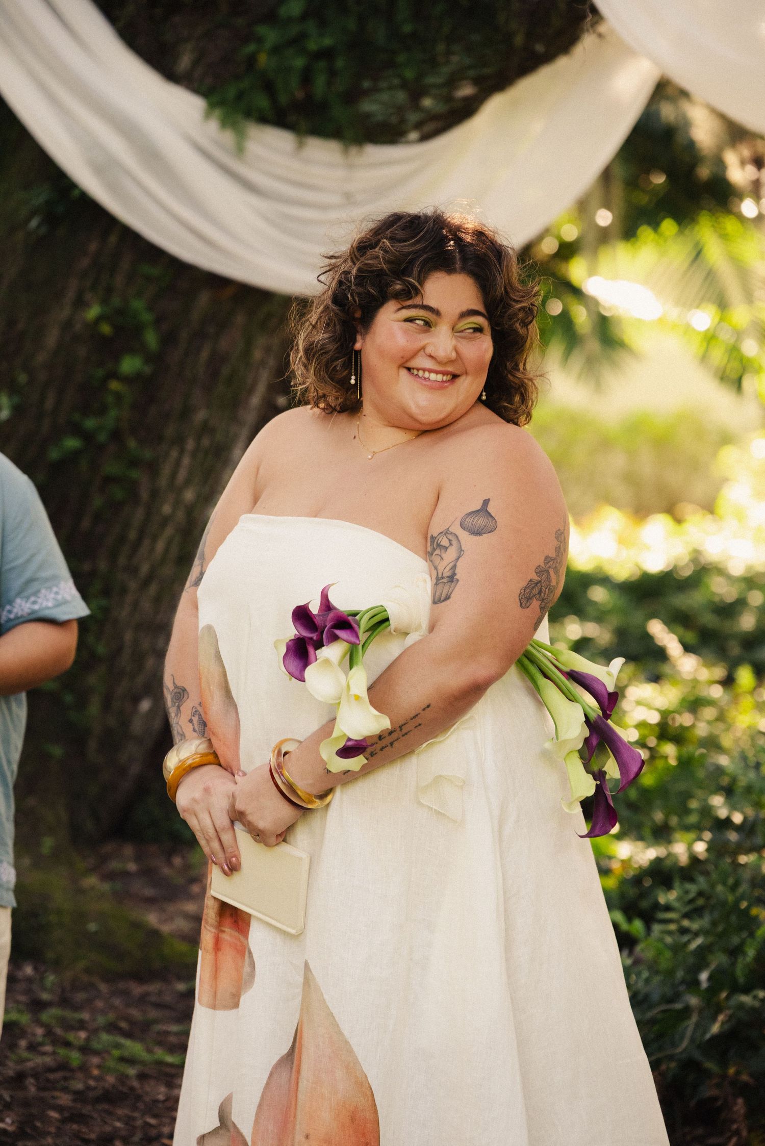 Wedding day portrait with white dress and purple calla lily bouquet.