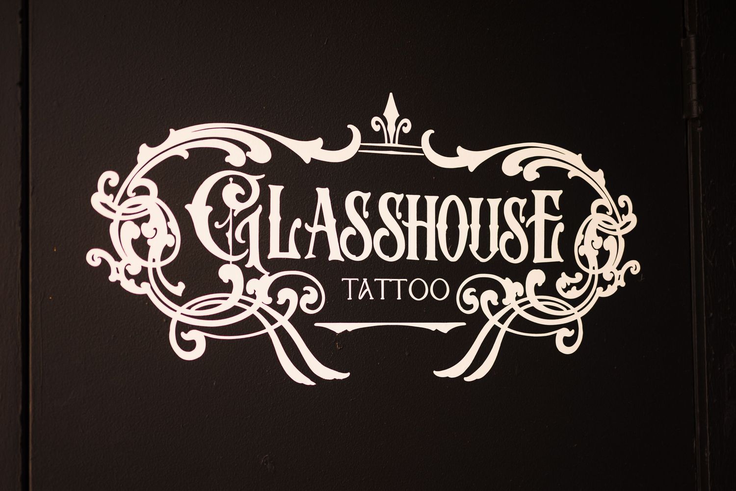 Ornate vintage-style text logo designs in white against a black background.