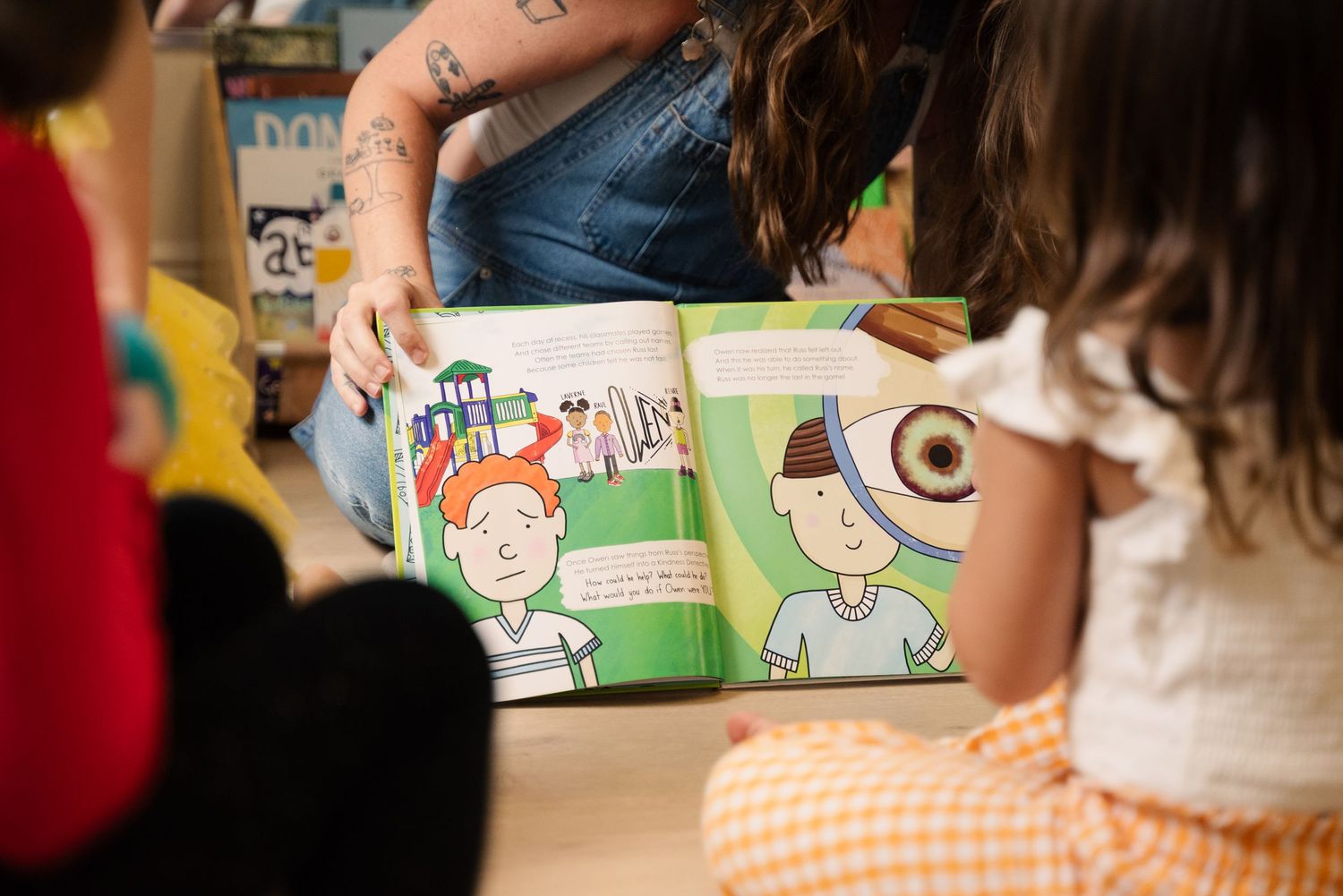 Children reading books together in a classroom setting.